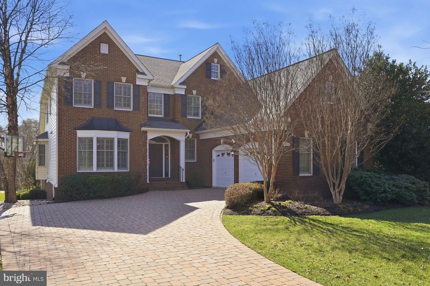 Situated in the prestigious Belmont Country Club community of Ashburn, 20018 Palmer Classic Parkway is a stunning traditional residence that seamlessly blends timeless architecture with sophisticated modern updates. Originally built in 2004, and thoughtfully renovated throughout, this impressive home offers more than 4,700 finished square feet across three beautifully designed levels, highlighted by the highly desirable main-level primary bedroom suite. Perfectly positioned on a generous .32-acre lot, the property features a private rear deck with covered sitting area and lower level patio backing to mature trees and the golf course, creating a serene backdrop which is ideal for both everyday living and unforgettable entertaining.

Thoughtfully designed for comfort and functionality, the home features 3 spacious bedrooms and 3.5 baths, blending classic detailing with modern updates. The main level welcomes you with a dramatic two-story foyer and an impressive two-story family room filled with natural light, seamlessly connected to the fully renovated kitchen. The kitchen is a true centerpiece, showcasing granite countertops, premium appliances including a KitchenAid refrigerator, Jenn Air gas stove and Jenn Air dishwasher, and a well-designed layout ideal for entertaining. A bright breakfast room provides access to the covered rear porch complete with a built-in TV, along with additional deck space for expanded outdoor living. A separate dining room offers a refined setting for formal occasions. The main-level primary suite serves as a luxurious retreat, highlighted by vaulted ceilings, a comfortable sitting area, and two walk-in closets with custom organizing systems. The recently renovated en-suite bath offers a spa-inspired experience with a separate soaking tub and shower, delivering both elegance and relaxation.

The lower level is designed for ultimate entertainment and leisure. Enjoy a dedicated theatre room with tiered seating, built-in projector, and screen for an immersive cinematic experience. A fully equipped gym with mirrored walls and specialty gym flooring provides convenience for at-home workouts. The expansive new wet bar area is a standout feature, complete with beverage refrigerator, abundant cabinetry, and floating shelves, opening to the billiards area which is ideal for hosting guests. This level also includes a full bath and a versatile den, offering flexible living options. The lower level opens directly onto the rear covered patio which features a built-in grill, a built-in “Green Egg,” and a striking outdoor fireplace with a TV mounted above—creating a true outdoor living room perfect for year-round enjoyment.

A two-car garage and extended driveway provide ample parking and storage, while the rear yard offers privacy and endless possibilities. Residents of Belmont Country Club enjoy a prestigious gated setting known for its scenic surroundings, beautifully maintained homes, and access to premier community amenities, all within close proximity to shopping, dining, and major commuter routes.

Blending timeless style, thoughtful upgrades both inside and out, and a premier Ashburn location, this exceptional property offers the space, setting, and elevated lifestyle today’s luxury buyers seek.