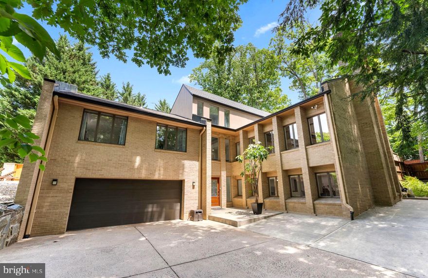 Introducing a groundbreaking contemporary residence beautifully sited on sought after North Kirby Road in sought after McLean.  10 ft ceilings, dramatic walls of glass, a two story Family Room and a three story stairway.   Every space in this very special home has been completely and thoughtfully remodeled to the very highest level, including stunning new baths, new mahogany 5-inch wood flooring and Porcelanosa lower level floor tiles and stair treads.  Additional upgrades include new roof, gutters & skylights, new solid wood doors and hardware, crystal chandeliers, updated HVAC with Nest thermostats and upgraded outlets and switches.  The new Kitchen is a chef’s dream with Konst SieMatic german cabinetry, Miele built-in appliances including a steam oven, Porcelanosa backsplash and Cambria quartz surfaces including a quartz waterfall style central island. The lower level with new LVP flooring has a central Recreation Room/Gym, as well as a quartz Bar area, Theatre Room w/projector, Expansive Storage Room, and remodeled extra-Large Garage with 60 Amp Power Supply for EV charging, full LED lighting, Race Deck flooring and wall-mounted door opener with insulated garage door. The exterior features an extended 8-plus car driveway, and the Kitchen opens to a large flagstone Patio and Deck with concrete and brick wall, surrounded wood fencing, and a beautiful vegetable garden.  The rear of the home also features mature professional landscaping, a playground set and an abundance of privacy.  The property offers a very convenient commute into DC, is within two blocks of the CIA, and for nature lovers and exercise enthusiasts, a stones throw from The Potomac River.  All located in the highly desirable McLean school pyramid.  You will not want to miss a chance to tour this stunning residence!