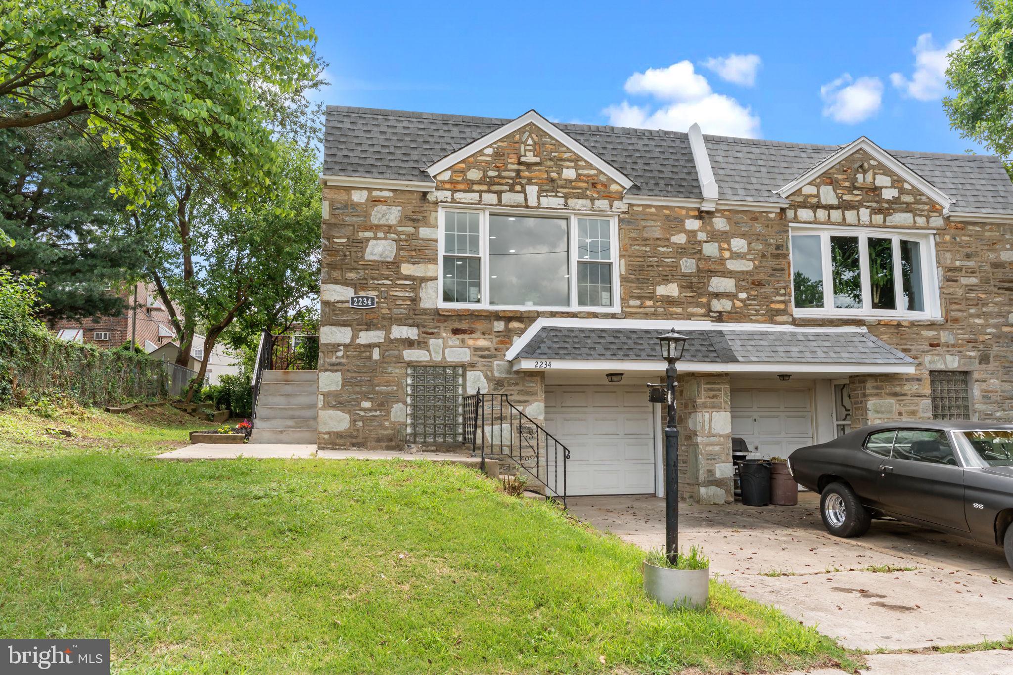 Beautifully renovated stone-front twin situated in the heart of Rhawnhurst that is as close to new construction as you can get. Arrive to find a private driveway that provides off-street parking and beautifully landscaped grounds. Enter and be prepared to fall in love as you will be in awe with this amazing renovation that pays meticulous attention to the details. The main living area has new luxury vinyl plank wood floors, recessed lights and fresh paint throughout and offers an open concept with a spacious living room with new windows that provides an array of natural light, dining area and a gourmet kitchen that is a chef’s dream complete with an abundance of shaker cabinets with crown moldings and gold hardware, Quartz countertops and subway tiled backsplash, oversized sink with gold faucet and all new Frigidaire stainless steel appliances including 5-burner gas range, built in microwave and dishwasher, and French door refrigerator that is included and additional. The rear of the main level hosts 2 spacious bedrooms, both with ceiling fans and double closets, as well as the stunning hall bathroom with oversized tiled floors, shower/soaking tub combo, new modern vanity with mirror and accent shelves. The lower/ground level is fully finished and features a huge living area with an entertaining nook with Granite, waterfall counter and undermounted refrigerator, a spa-like 3-piece ceramic tile bathroom with walk in shower that has a marble tiled surround and gold accent hardware, and a modern vanity with curved mirror. The remainder of the lower level hosts the 3rd bedroom with a nice sized closet, separate laundry room with washer and dryer that are included and provides interior access to the 1-car garage with electric opener and rear access to the private yard that is completely fenced. This lower level offers endless possibilities for an in-law-suite, awesome entertainment area, or with proper approvals, can act as an apartment with private entrance that could generate rental income. Nearly everything in this house is brand new including brand new central air, newer heater and water heater, newly coated roof, replacement windows throughout, new interior and exterior doors, new plumbing, updated electrical panel, and the list could go on and on. Conveniently located close to great restaurants, shopping, schools, I-95, and Route 1 and public transportation at your doorstep. Will not disappoint. ***VIEW THE VIDEO WALK THROUGH***