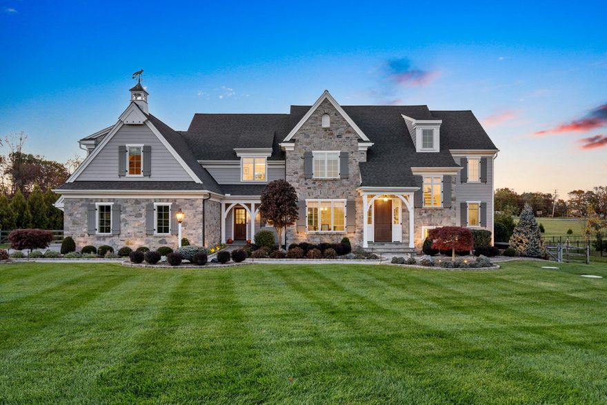 At the end of a cherry tree lined driveway, 25 New Whitehorse Way greets you with storybook charm. Built by locally renowned Hellings Builders, this award-winning French Country Newtown Model has been both impeccably maintained and beautifully landscaped. Timeless elegance is exuded by the stone and classic HardiPlank exterior, while the sparkling Armond pool and spa surrounded by a Pennsylvania bluestone patio promises a future of outdoor fun and al fresco dining. 
Step inside to discover an inviting open floor plan that showcases a gourmet kitchen, complete with quartz countertops, a six-burner Wolf cooktop with griddle, Wolf wall oven, Subzero refrigerator, Instant Hot dispenser, under sink water filter, and Bosch dishwasher. Custom kitchen cabinetry by Goebel’s provides optimal storage, with integrated display lighting and under cabinet lighting. The kitchen unfolds seamlessly to the Great Room- featuring a built-in entertainment center and cozy gas fireplace perfect for both entertaining and everyday living. Large casement windows ensure that the main living level is bathed in natural light. An integrated speaker system sets the mood of your choice, and delivers your favorite music to the Kitchen, Great Room, Office, Patio and Pool area, as well as the Primary Bedroom Suite. The formal Dining Room and Breakfast Area provide versatile options for dining experiences, while the custom pantry and walk-in closets offer ample storage solutions. Find privacy by passing through double doors to a generously proportioned office, flanked with custom cabinetry and appointed with quartz countertops. Crown molding, cased openings, and a two-story ceiling in the Foyer provide a grand welcome to those entering through the mahogany front door. Take the iron spindled stairs to the second story to access all five bedrooms. Find sanctuary in the Primary Bedroom, with an airy cathedral ceiling, dual walk-in closets, and dressing area. The luxurious Primary Bathroom is a true retreat, featuring a spa-like bathroom with dual vanities and marble countertop, a soaking tub, walk-in shower with multiple shower heads, and Toto Neorest Smart Toilet. Two of the auxiliary bedrooms feature en suite bathrooms, and the other two share a spacious J&J bathroom. Each additional bedroom is generously sized, ensuring comfort for all, and flexibility for alternative usage. A booster pump supplies fantastic water pressure to all bathrooms, even when the sprinklers are also watering the lawn. An upper-level laundry room adds convenience to daily routines and has the capacity to serve either an electric or a gas clothes dryer. The unfinished basement, spanning the entire footprint of the home, presents endless possibilities for customization. A double door daylight walk-up from the basement provides direct access to the rear yard. The property spans 1.21 acres and is fenced for privacy and pool safety. The three-car garage is a dream, with custom soft close cabinetry and slat walls for organization and storage, a built-in work table with butcher block top, and an epoxy sealed floor. A comprehensive security system, motion sensor flood lights, and extensive landscape lighting provide peace of mind. The sophisticated buyer will appreciate smaller details, such as the solid core interior doors and upgraded window casings throughout the home, Elkay utility sinks in the mudroom and laundry room, Emtek hinges and door hardware, Decora dimmable rocker switches, white oak hardwood floors stained on site, custom interior paint, a whole house (400 amp) Briggs/Stratton Standby Generator, and AprilAire Humidifiers. Conveniently located: A short distance to the King of Prussia Mall, Valley Forge Park, Main Line shopping and dining, and major roadways including the 76-slip ramp. Served by highly rated Great Valley School District public schools.