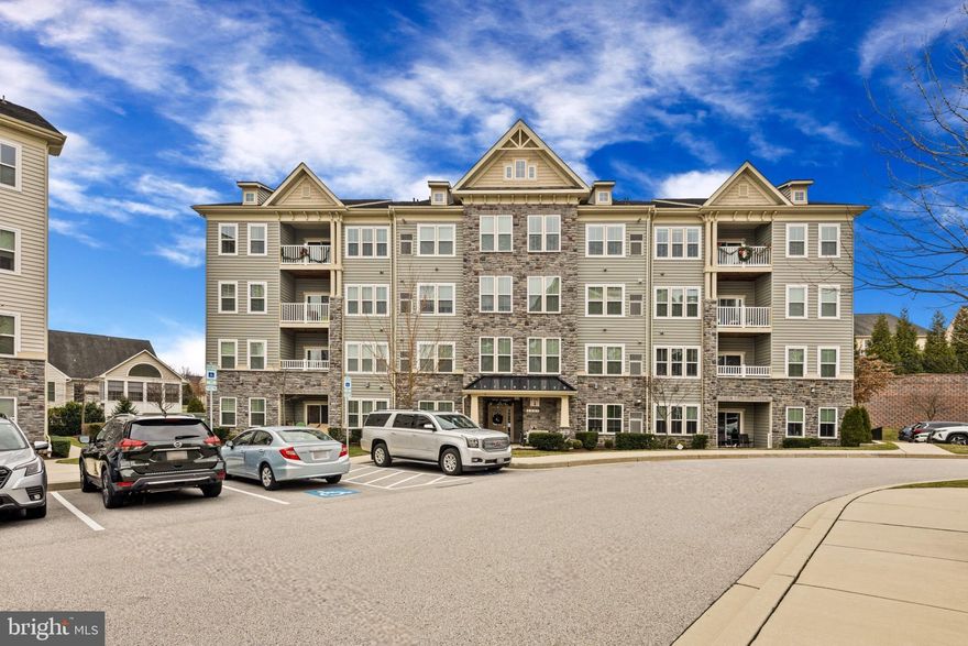 Freshly painted contemporary condominium offering 1,700+ square feet of thoughtfully designed living space with 2 bedrooms and 2 full baths in the sought-after Waverly Mews 55+ community. Located on the elevator-accessible 4th level, the main level foyer features laminate flooring and opens to an open-concept great room with tall vaulted ceilings. Carpeting flows into the dining area, which is accented by a timeless chandelier and offers access to a Trex® balcony with tranquil, private views. The eat-in kitchen is beautifully appointed with stainless steel appliances, granite countertops, ample cabinetry, an island, and a breakfast bar overlooking the main living space. The primary suite features double closets, including one walk-in, and a beautiful ensuite bath with a dual-sink vanity. The second bedroom is spacious and provides convenient dual entry to the second full bathroom, also accessible from the hallway. A versatile loft space offers endless possibilities for a home office, reading nook, or creative retreat. Waverly Mews provides vibrant 55+ living with outstanding amenities, including a community center, fitness center, scenic paths, a pool, and beautifully maintained common areas.