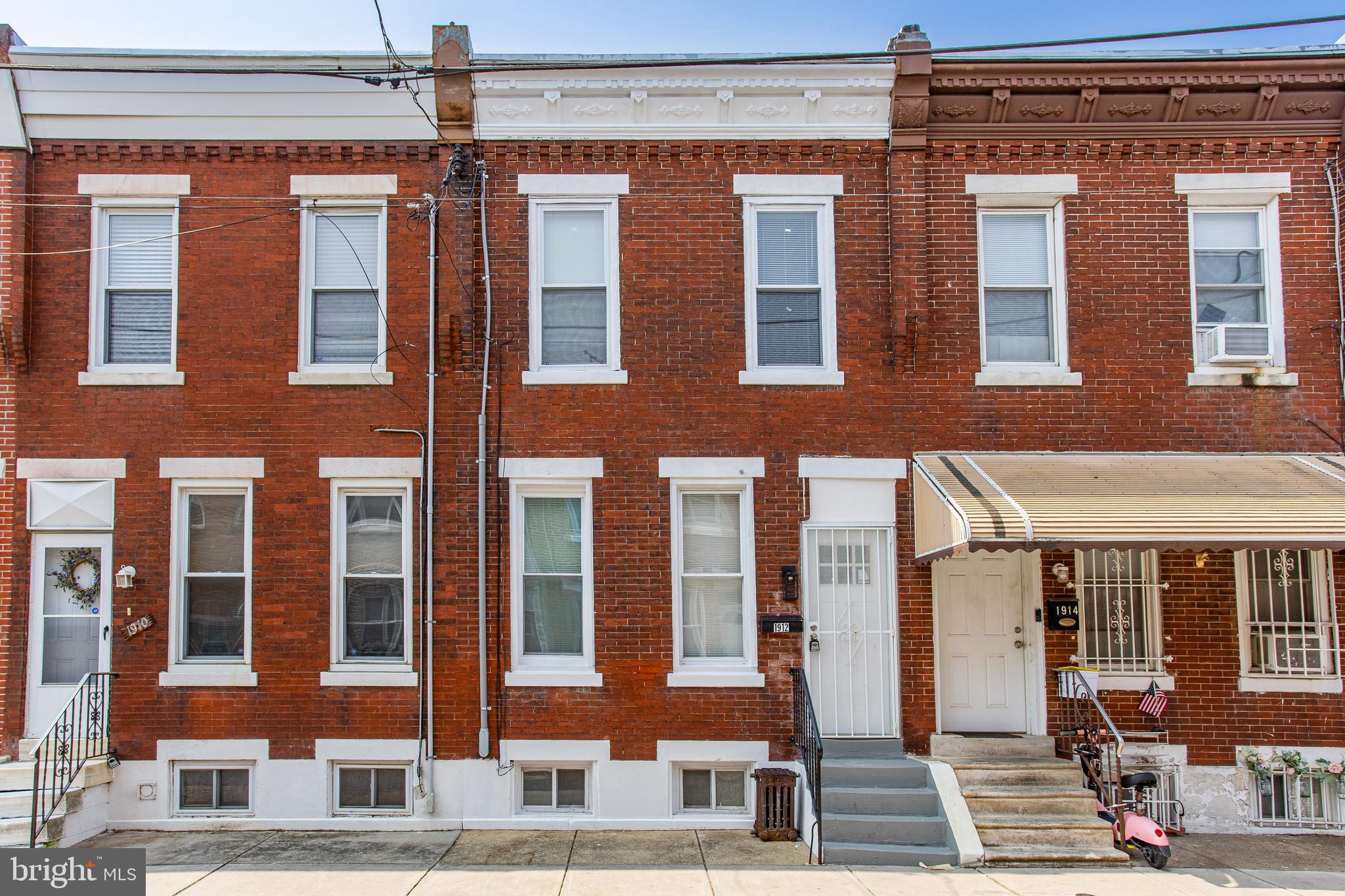 Welcome to 1912 Hoffman Street, a beautifully updated 3-bedroom, 1.5-bathroom rowhome located in the vibrant and sought-after West Passyunk neighborhood of Philadelphia. This home has been thoughtfully renovated with tons of modern touches throughout! Step inside to discover a bright and welcoming living room featuring durable luxury vinyl plank flooring and beautiful crown molding and recessed lighting that flows to the dining room. Just past the living room, the spacious dining room provides an ideal setting for everyday meals or entertaining guests, highlighted by a sleek modern lighting fixture. The living room and dining room both feature modern wooden wall accents. The kitchen, situated at the rear of the home, boasts luxury vinyl plank flooring, brand new modern stainless steel appliances, white cabinets, stunning countertops, unique backsplash, and convenient access to your private back patio—ideal for morning coffee or unwinding after a long day. Upstairs, the primary bedroom offers a peaceful retreat with continued luxury vinyl plank flooring. Two additional bedrooms on this level provide flexibility for children, guests, or a dedicated home office. The full hall bathroom features tile flooring and a gorgeous tub/shower combo. The finished lower level adds even more livable space, complete with a laundry area, a convenient powder room, and plenty of room to create a media space, playroom, or workout area. This home truly has everything you need—and it's all just a short walk from the shops, restaurants, grocery stores, and entertainment along W. Passyunk Avenue. You are also nearby the Philadelphia Sports Stadiums, Center City, and a short drive to the Philadelphia International Airport. Don't miss your chance to call this move-in-ready gem your new home!