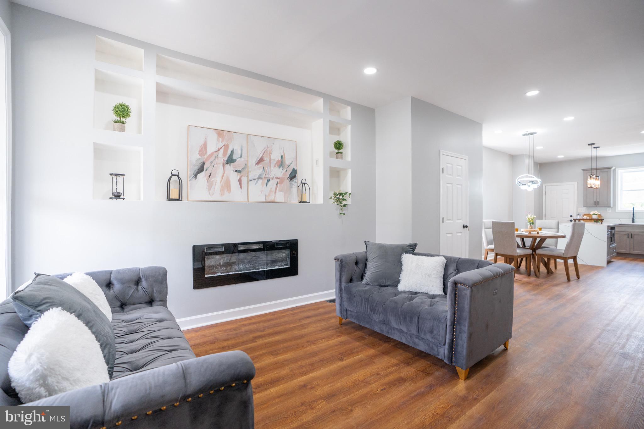 Fully renovate a brick townhouse in an up-and-coming neighborhood in Baltimore City, MD. The house was renovated from top to bottom, featuring three bedrooms and two full bathrooms upstairs. The inviting living features an accent wall with a built-in chimney and space for TV. The open concept allows the air to flow freely between the living room, dining room, and kitchen. The heart of the house is the kitchen, featuring custom-made cabinets, stainless steel appliances, and quartz countertops, which make this kitchen a dream come true. The massive island with cascading quartz will keep your eyes on. There is also a half bathroom on the main level. The house has new LVP on the levels and much more. Don't miss the opportunity to see this beautiful home, conveniently located near public transportation, shopping, and restaurants.