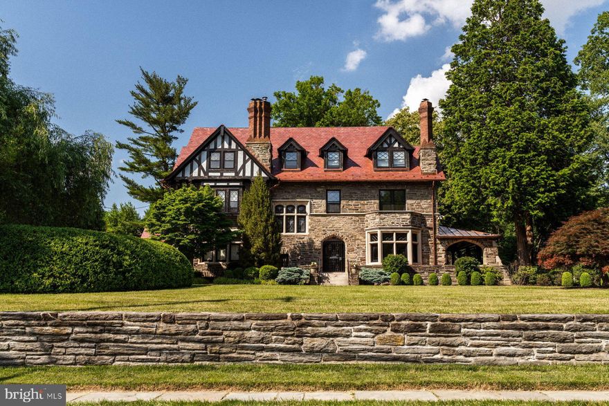 Known as “Seven Chimneys,” for the seven unique tiled fireplaces and stacked chimneys, this timeless stone Tudor nestled in the heart of Chestnut Hill exudes charm and elegance. Perfectly situated on a private and picturesque lot, this residence offers classic architecture within walking distance to the vibrant shops and restaurants of Chestnut Hill.
Curb appeal abounds as you approach the home, which features a gracious front yard which sets the house back from the street. As you arrive you will notice recent upgrades to the exterior including new copper gutters and flashing, and a new, red slate roof which was recognized with a Preservation Award from the Chestnut Hill Conservancy.
Upon entering, you are greeted by a proper front foyer with original hardwood floors, beautiful leaded windows and intricate woodwork. The spacious first floor includes a formal living room, a secondary den space, an expanded kitchen, dining room and powder room. 
A grand front staircase takes you to the second floor where you will find the main bedroom suite, complete with study that affords privacy and flexibility to use as a home office or add a walk in closet. On the other side of this floor find two bedrooms, full bath and sleeping porch. Take the back stairs to the third floor, where you’ll find a large room perfect for entertaining, plus two more bedrooms and full bath. 
Outside, the magical grounds are meticulously landscaped featuring mature trees, a sunken garden, a large vegetable garden area, a putting green, and a pool. Enjoy summer evenings on the expansive covered stone patio, ideal for outdoor dining and entertaining. 
Conveniently located adjacent to the Wissahickon Park and a block from the beloved Crefeld trailhead, outdoor enthusiasts will appreciate access to miles of hiking and biking trails amidst breathtaking natural scenery. The walkable Chestnut Hill neighborhood offers a plethora of boutiques, restaurants, and cultural attractions like the Morris Arboretum and Woodmere Art Museum, ensuring there's always something new to explore. 
On the market for the first time in decades, don’t miss the opportunity to own a piece of Chestnut Hill history.