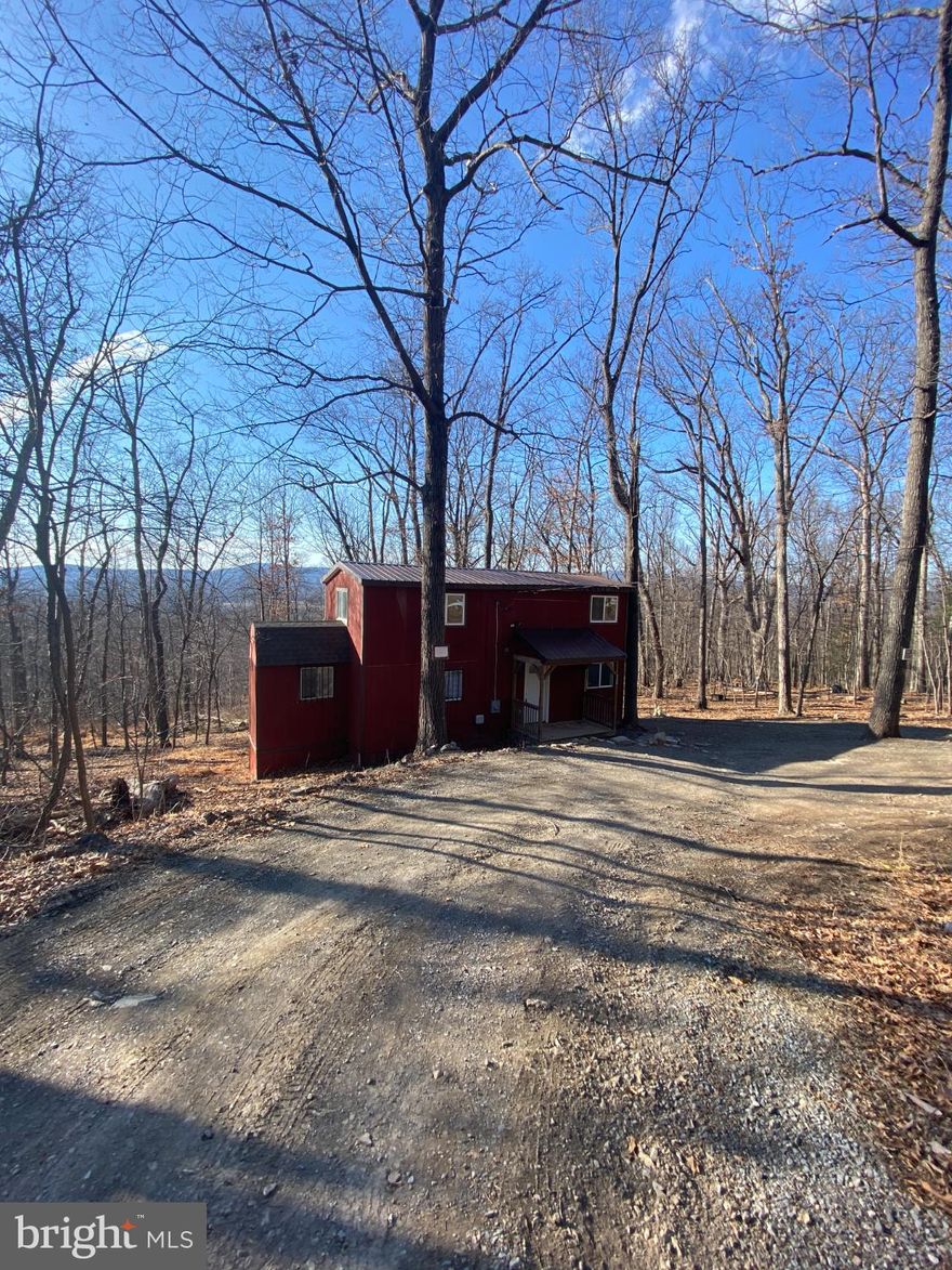Serene lodge-style home in Glenwood Forest subdivision featuring 3 bedrooms and 2 full baths. Enjoy the wooded lot, rear deck, and great views.