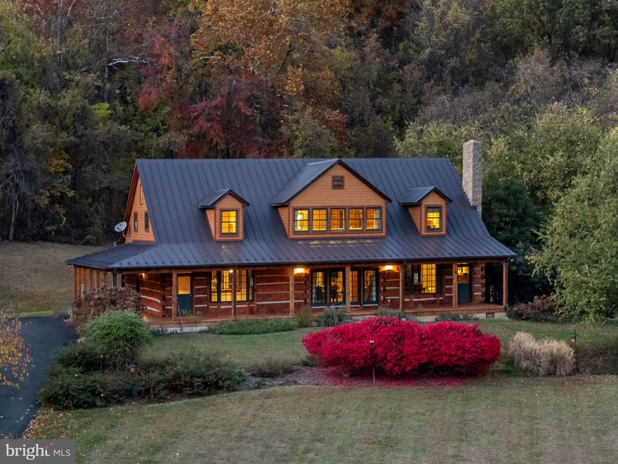Handcrafted timber and log, accented with stone and pristine views, Bear Wallow Farm is a 42-acre enclave for family and friends with a main residence and two guest cabins in an unparalleled setting—proof you don’t need Montana when you have Rappahannock. This place is special.
Sited on a gentle rise among pastures and ponds, wrapped in mountain views, this custom circa 2000 white pine log home of 5,750 sq. ft. stands apart in quality but was designed to complement the land, using nature’s materials- pine, cedar, cherry, maple, walnut, copper, granite, stone, and slate.   The main house (2 bedrooms) and two guest cabins, built with the same level of detail and richness, provide 4 total bedrooms in this compound, located in a coveted region of Rappahannock.
The main level breaths with its vaulted ceiling, natural light and a floor plan that naturally flows. French doors throughout connect easily to the outdoors, bringing in views, light, and fresh air. The living room features a 15-foot-wide stone fireplace opposite two stories of south-facing windows. Overhead, two single-length hand-hewn beams span 40 feet, one of the home’s best architectural details. The dining area and kitchen, complete with custom cabinetry, an oversized island, and Viking and Sub-Zero appliances, seamlessly join the space. The gracious library leads to the main-level primary suite that opens to a rear patio with spa. Renovated in 2023, the primary bath is premium with a clawfoot tub, glass-enclosed shower, brass fixtures, and rich tiger maple cabinetry. Radiant heat throughout the main level adds a subtle warmth, creating a comfortable home.
The upper level offers stunning views and flexible spaces for workouts, reading, or home offices with Starlink internet. A large room, currently a bedroom, can serve as an art studio, study or more. (County-wide broadband is scheduled to be completed by Fall 2026.)
A tavern-inspired space with a pressed tin ceiling and bar—ideal for gatherings and game nights surprises in the lower level. A wine room, home theater, spacious office, and coded safe room are also on this level. 
The two guest cabins have large bedrooms, a fireplace, full bath and a kitchenette (no stove) and allow guests to settle in and enjoy their own space and privacy.
The pastoral setting of open hayfields offers possibilities— future equestrian facilities, gardens or hunting in both field and mountainside. The equipment barn (4 enclosed bays, 3 open) with concrete floor accommodates tractors, 4-wheelers, tools and equipment. Inside, a commercial kitchen, bathrooms, walk-in cooler and freezer. The large woodworking shop is a craftsman's dream--fully conditioned is ready for projects.  Fun fact: the bar for Flint Hill’s beloved Griffin Tavern was crafted here. 
All just 20 minutes from Little Washington, home to the renowned Inn at Little Washington and Patty O’s Café and Sperryville, both offering restaurants, breweries, unique shops and more. 20 minutes to Front Royal, 30 minutes to Warrenton and 90 minutes to DC. Crafted over 20 years in harmony with the land, this one-of-a-kind property offers the essence of elevated Rappahannock living.
