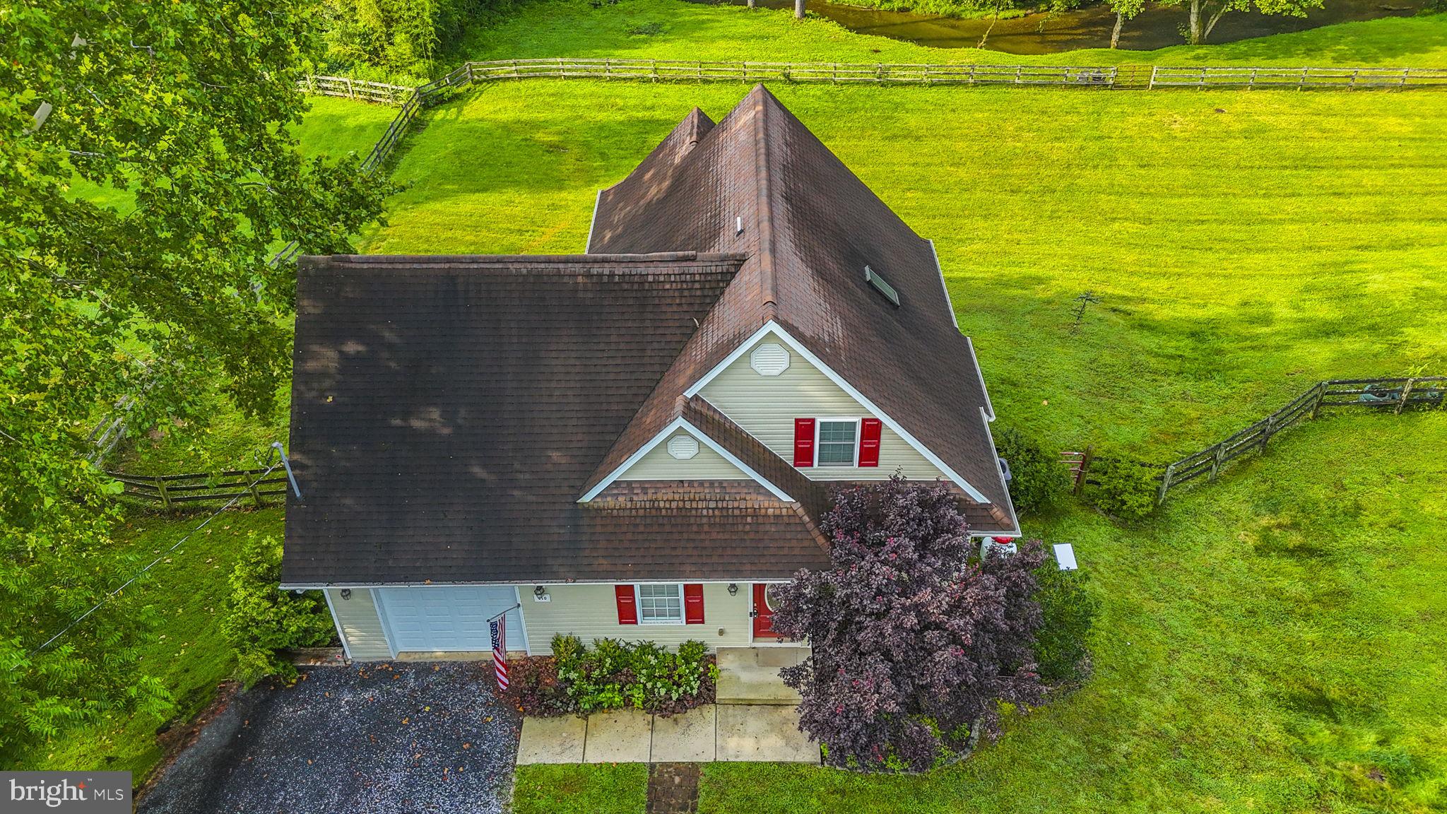 This cozy cape cod on 2.43 acres offers privacy and tranquility. Walk in on the main level where you'll find a coveted first floor bedroom with a full bath. The open concept features a kitchen with a breakfast bar and a comfy living room with a gas fireplace. Just off the dining area is access to the covered deck, where you can grill and chill or relax with your favorite drink and enjoy the view! Upstairs you'll find 2 additional bedrooms and another full bath. The basement is unfinished and ready for your touch. Turn it into a rec room, additional living space, or add another bedroom. There is also a rough-in to add another bathroom. Recent upgrades include a new HVAC system and a new water treatment system. This picture perfect lot comes with a fenced-in backyard and a creek that flows behind. Secluded on a dead-end road but just minutes away from shopping in Inwood, this home offers the privacy you want with the convenience you need!