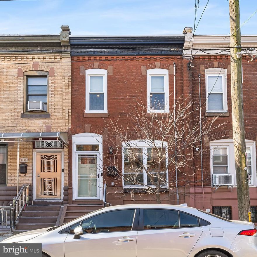 Welcome to 1816 Mifflin, a top-to-bottom renovation in a vibrant and walkable South Philly location. Featuring three bedrooms, including a primary with ensuite, a large finished basement, and soaring ceilings, this is a perfect opportunity for a new homeowner. You will immediately appreciate the handsome brick facade and intricate woodwork in the cornice. The first level offers a traditional rowhome layout but with its extra wide lot and 9 foot ceilings, it feels even more spacious. The exposed brick adds character and warmth to the space. The kitchen is updated with a waterfall quartz island, stainless steel appliances, white shaker cabinets, and tile backsplash. Double glass sliders allow plenty of natural light to pour in, and provide access to the well-sized private patio. Back inside, the first floor is rounded off with a convenient powder room. The basement provides additional living space, and could be utilized as a home office, gym, playroom, or more. There is a separate utility room for laundry and storage. The second level features three well-appointed bedrooms, and two full bathrooms. In the primary bedroom, you will find your own spa-like bathroom with rainfall shower and sleek vanity. The double closet can easily accommodate any wardrobe! The secondary bedrooms are nicely sized and also offer ample closet space. The hall bedroom offers a double vanity, fiberglass tub and a neutral palette. This home is a 12 minute walk to the Tasker-Morris Broad Street stop, a 15 minute walk to the heart of the Passyunk Avenue shopping corridor, provides easy access to all major highways, the Philadelphia International Airport and the sports complex. All major home components are less than 6 years old. The roof is less than a year old and comes with a transferable warranty. The french drain was also recently installed and also comes with a warranty, ensuring a low maintenance home! Don't miss this opportunity!