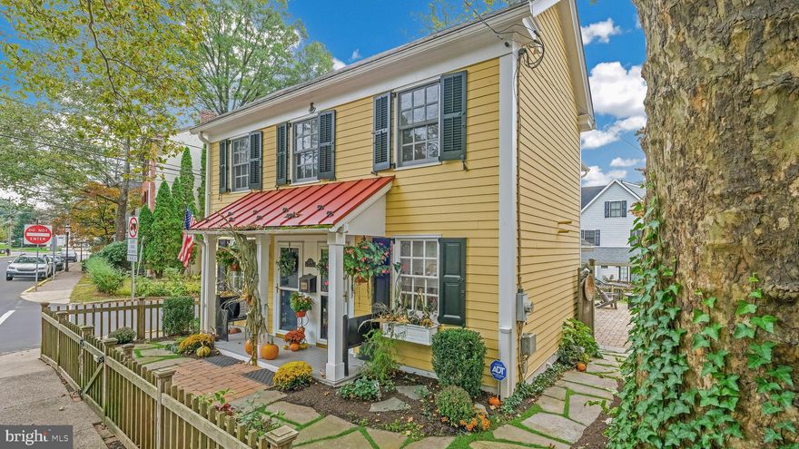 Tastefully restored historic home is now available in the heart of Doylestown Borough. This classic yellow Colonial sitting at the corner of Church and State is that home you’ve admired for years! Built in 1802 and restored in 2000, this 3 Bedroom/2.5 Bath Home oozes with curb appeal with its picket fence, window boxes, built-in black benches and Front Porch with colonial red metal roof. Step into the welcoming Living Room with its hand-scraped Hickory floors and wall of built-in bookshelves with glass cabinets above. This gracious room could be used as a Living Room or as a Dining Room and an Art Studio as the current owner did—it’s open to possibilities! The Gourmet Kitchen features Cherry cabinetry, Granite counters, white Farmhouse sink, newer Stainless appliances, pine ceiling with beams and porcelain tile floor that looks like wood. There is a sweet Breakfast Area bump-out with lots of windows and natural Light next to the Kitchen. The Kitchen is OPEN to the Family Room with a cozy Gas Fireplace with brick surround plus the mantle built by local artist, William Hoehne. A corner entertainment cabinet with built-in bookshelves adds to the room. French Doors open to a private brick patio that is great for entertaining and would be perfect for a fire-pit! Upstairs, the Primary Suite has a cathedral ceiling and a SECOND gas fireplace plus a walk-In closet and en-suite bath. Two more bedrooms plus a Hall Bath, a sweet overlook and a laundry room complete the Upstairs. Downstairs, there is a convenient Mudroom with cubbies and a side door that leads out to the landscaped yard that is completely fenced-in. The finishing touch of this charmer is the one-of-a-kind custom-built Carport complete with a quaint storage area with electricity, a window box and your own paver driveway! Attention to detail can be seen throughout this home with its Hardy Plank Siding, Anderson Windows, High Efficiency Bosch Water Heater, Newer HVAC (2022),  Spray Foam Insulation in Attic, Two Newer Gas Fireplaces, Extensive Landscaping including Perennials! This is the Doylestown Borough lifestyle that you have been looking for!  A short walk to the shops, restaurants, museums, library and train! Showings begin on February 1st with Open Houses on Saturday, February 3rd and Sunday, February 4th!