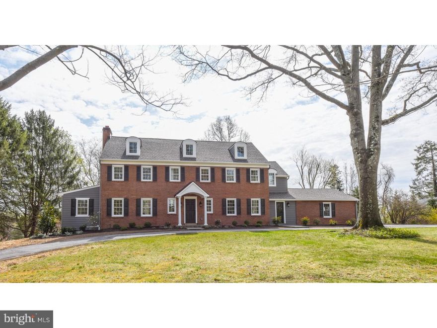 This spectacular brick colonial in Radnor Township has been completely renovated and expanded by Custom Builder, Sposato Homes into a 5 bedroom, 4.2 bath light filled home with a wonderful open floor plan, perfect for today's lifestyle. A semi-circular driveway with flagstone path leads to a portico - enter into the foyer with "select oak" site finished hardwood floors, deep crown molding and custom wainscoting. The beautiful hardwoods continue through the 1st floor, up the stairs, down the 2nd floor hallway and through the master suite. To the right of the foyer is the Dining Room with custom wainscoting, to the left is the Great Room with gas fireplace and full height custom wood mantel. A glass paned door leads to the office/den. The great room opens to the large eat-in kitchen with White Cabinetry and Absolute Black Honed Granite counters and island, white subway tile backsplash, Stainless GE Monogram Appliances including a 6 burner gas range, dishwasher, refrigerator and microwave drawer in the island and a stainless farmhouse sink with windows overlooking the back yard. Pella sliding doors lead out to the rear deck with steps down to the level yard. Off the kitchen, is a tiled mud room with built in bench and cubbies, 2 coat closets, a large pantry with built in shelving and Powder room with Carrera topped vanity.  Access to the attached 2 car garage and a door to the front. The 2nd Floor includes a spacious Master Suite with 2 outfitted walk in closets, an en-suite bath with porcelain tile floor, freestanding soaking tub, double sink vanity with Carrera top, stall shower with seamless glass enclosure, 2 shower heads and bench and private water closet. Two additional bedrooms with walk in closets and en-suite baths and convenient 2nd floor laundry room with tile floor and white cabinetry completes this level. The open staircase leads to the finished 3rd floor with 2 additional bedrooms and hall bath. Off the foyer is an open staircase with hardwoods leading to the finished lower level with windows and a door with stairs to the back yard and plenty of space for play, fitness, and TV. A powder room and closets with utilities/storage complete this level. Other features include Pella windows throughout, recessed lighting, dual zoned heat and Manaboc water system. This beautiful home is serviced by award winning Radnor Schools and is conveniently located close to the train, 476, and 76 with easy access to the city and airport.