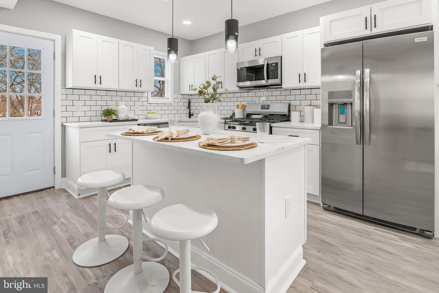 Gorgeous Fully Renovated Home in Parkville (Baltimore County) with over 1500 Square Feet of Living Space.  The Main Level has an Open Floor Plan with a Fully Renovated Kitchen with Brand New Stainless Steel Appliances, Gas Range, Refrigerator with Ice Maker,  Built In Microwave and Quartz Countertops.   The kitchen is open to a Large Dining Area and Living Room.  There is also a  First Floor  Bedroom and a  Beautifully Renovated Full Bath.  Upstairs you  have 3 Additional Bedrooms and 2 Renovated Full Baths.  The Primary Bedroom has an En Suite Bathroom and Large Walk In Closet.   The Lower Level is finished and could be used for an additional Family Room, Home Office or Gym.     Luxury Vinyl Flooring Throughout, Recessed Lighting, Brand New Roof, HVAC, Water Heater and Washer/Dryer.    Home has an Attached Garage.   This home is on a Quiet Street and is close to Shopping, Restaurants, Parks and easy access to Rt. 695.   This is a must see and will not last long.