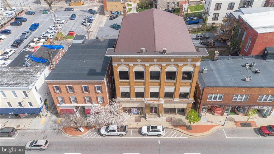Historically Significant Piece of Hagerstown's History - Landmark Renaissance Revival Building, three-stories of brick & stone construction, monumental pilasters spanning two-stories, ornate modillioned cornice with dentil & decorative corner pendants. Listed on National Register of Historic Places. Circa 1907 this building was dedicated in 1908 by Knights of Pythias as a gathering place dedicated to "friendship, charity & benevolence."  The third floor ceremonial hall is early venue where Patsy Cline's musical career began in 1952, transforming her from local talent to a superstar of American Music.  This 12,900 sq ft building has a clean open canvas, ready for adaptive re-use by the next developer, investor or visionary.   Stunning architectural details, original staircase, wood floors, millwork and high ceilings, metal roof approximately 10 years old...imagine the possibilities!    In short, it’s not just a redevelopment site—it’s a piece of Hagerstown’s cultural and architectural legacy with built-in storytelling value, especially for music history and early 20th-century fraternal life.    Today the property is Center City Mixed Use Zoning offers blend of commercial, residential, offices, shops, event space, boutique/hospitality, live/work environment, etc.   High visibility, foot traffic and proximity to local amenities, government offices & cultural attractions.   Don't miss this blank slate re-development opportunity in one of Maryland's most historic downtowns.