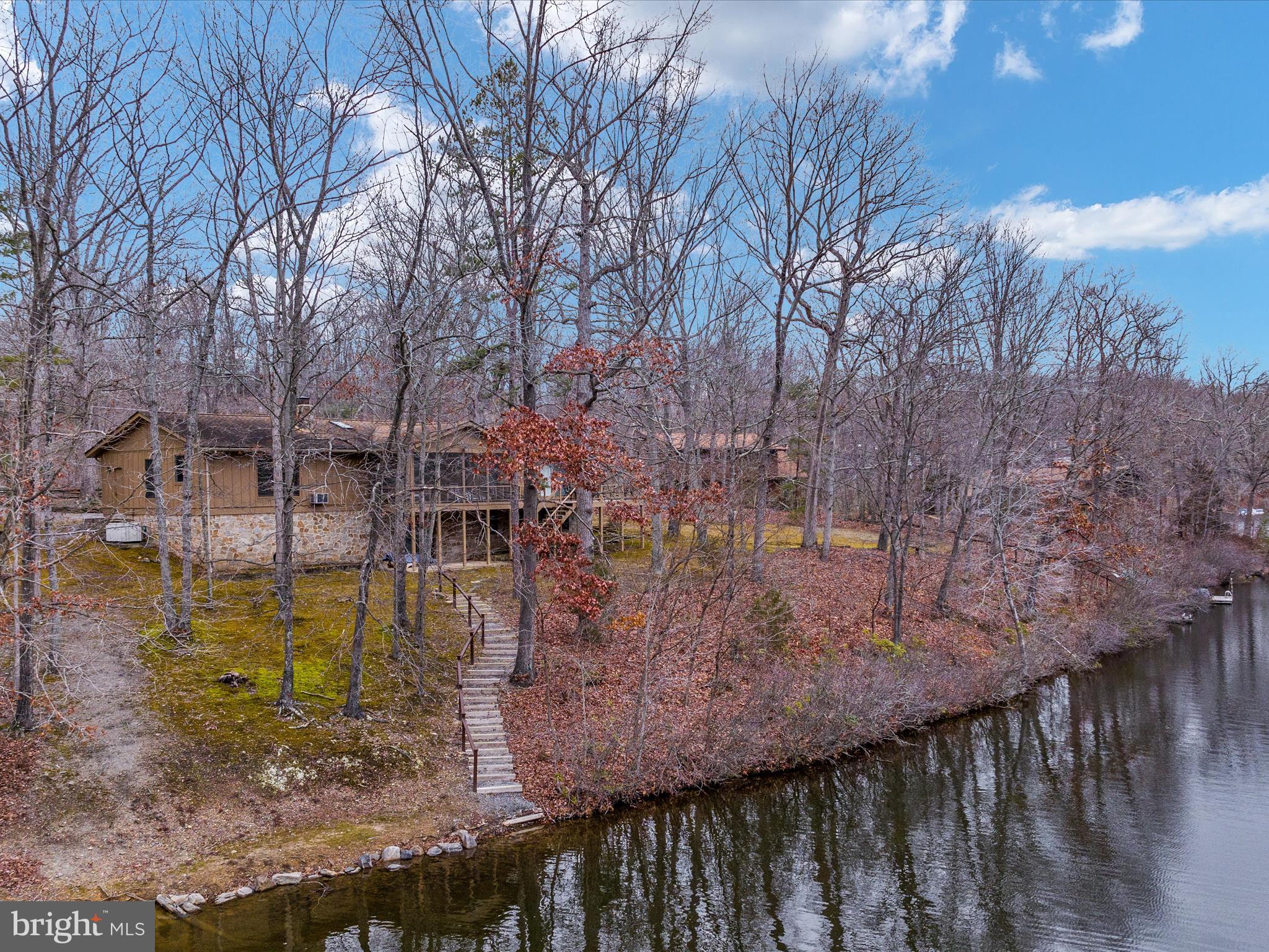 OPEN HOUSE CANCELLED, WE ARE UNDER CONTRACT.
Welcome to your personal slice of paradise! This stunning lakefront property, nestled on close to an acre in the sought after Shannondale community, offers a perfect blend of tranquility and modern living. With over 2,700 sq ft, this home provides a private escape with breathtaking views of the 54-acre lake. Whether you are looking for a weekend retreat or a permanent place to call home, you won’t want to miss this opportunity.
Built in 1979 this meticulously maintained, spacious, and light-filled property has had many upgrades along the way. Build a fire in the gorgeous wood-burning fireplace while overlooking the lake on a chilly morning. Or cozy up with your favorite book in the reading nook complete with its own built-in bookshelf. With plenty of room on the main level, there are 3 bedrooms in total, each providing ample space and natural light. One bedroom is complete with its own sliding glass door, leading you to a private and spacious deck. The primary bedroom comes with an ensuite bath, providing a private oasis for relaxation and convenience. In addition to the ensuite, there is another well-appointed bathroom and a convenient powder room, ensuring comfort and functionality for all residents and guests.
Perfect for entertaining, the lower level has an additional bedroom with a full bath and a wet bar. It even has its own wood stove to keep you warm and cozy. A third sliding glass door opens up to another gorgeous view of the lake. There is abundant storage throughout the home, as well as an outdoor shed.
For outdoor living, residents have exclusive access to a recreation area with amenities such as swimming, volleyball courts, electric and non-motorized boat ramps, and a clubhouse. No power boats are allowed on the lake, ensuring a peaceful and eco-friendly environment. Kayaking, canoeing and swimming and fishing make for a wonderful summer on the water.
Situated only 40 miles from Dulles International Airport and 60 miles fromWashington DC, this property offers a convenient retreat. With a proximity of 5 minutes to the 1300-acre Shannondale Springs Wildlife Management and access to the Shenandoah River, outdoor activities are abundant.
This lakefront haven, with its rich history, thoughtful design, and serene surroundings, offers an idyllic retreat for both leisure and potential long-term residence.