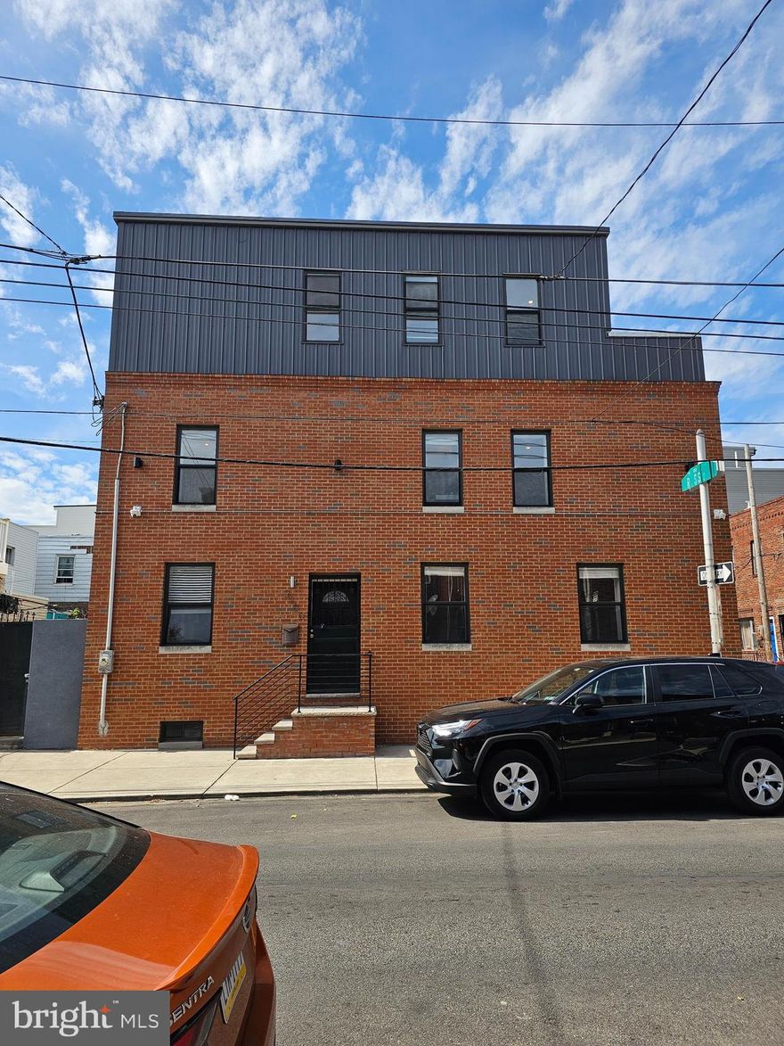 Welcome to 2100 Cross Street — a modern corner property built in 2018, offering a spacious and stylish lifestyle in the heart of booming Point Breeze. This 3-bedroom, 2.5-bathroom home spans three levels and boasts contemporary finishes, an open-concept layout, and an abundance of natural light.

The main floor features a large living and dining space with sleek flooring and recessed lighting, flowing seamlessly into a well-appointed kitchen with quartz countertops, stainless steel appliances, and custom cabinetry — perfect for entertaining or quiet nights in.

Upstairs, you’ll find three generously sized bedrooms, including a luxurious primary suite with a walk-in closet and en-suite bath. The third-floor landing opens to a private walk-out balcony showcasing stunning Center City skyline views — ideal for morning coffee or evening relaxation.

Additional highlights include central air and heat, in-unit laundry, ample storage space, and a full basement for added flexibility.

Located just minutes from restaurants, shops, public transit, and all that Center City has to offer, this home is a must-see for anyone looking for modern city living with a neighborhood feel.