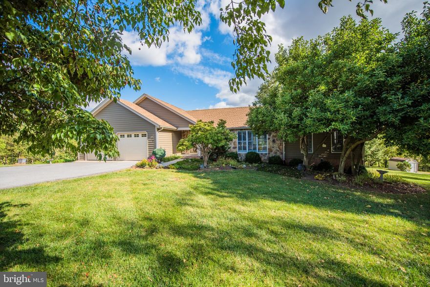 This lovingly cared for ranch home, finished on both levels with an awesome glass sun room addition, is ready for new owners. Handicapped accessible with ramp installed in garage.  The house is custom built as is the detached 16x20 building.  The HVAC system is premium...top of the line Trane.   The vacant lot next door is owned and maintained by the Wall family who live directly across the street.   Custom closets installed by The Container Store.  One of the bedrooms in the basement (the one without carpet) was used for crafting, could also be an office, additional bedroom or school room. What's your vision. Here are some of the upgrades the sellers have made since 2011. Added garage door openers, new HVAC in 2018, New Roof 2018, added ceiling fans 2017, updated master bath 2017, added blown in insulation in attic 2017, enclosed glass porch 2015, water treatment system 2015, updated kitchen 2013 Plus, all the lower cabinets have pull out shelves.  Added outbuilding 2013. The finished lower level walks out to lower patio, terraced yard and box gardens. This wonderful property awaits new owners. Make it yours before the new year!