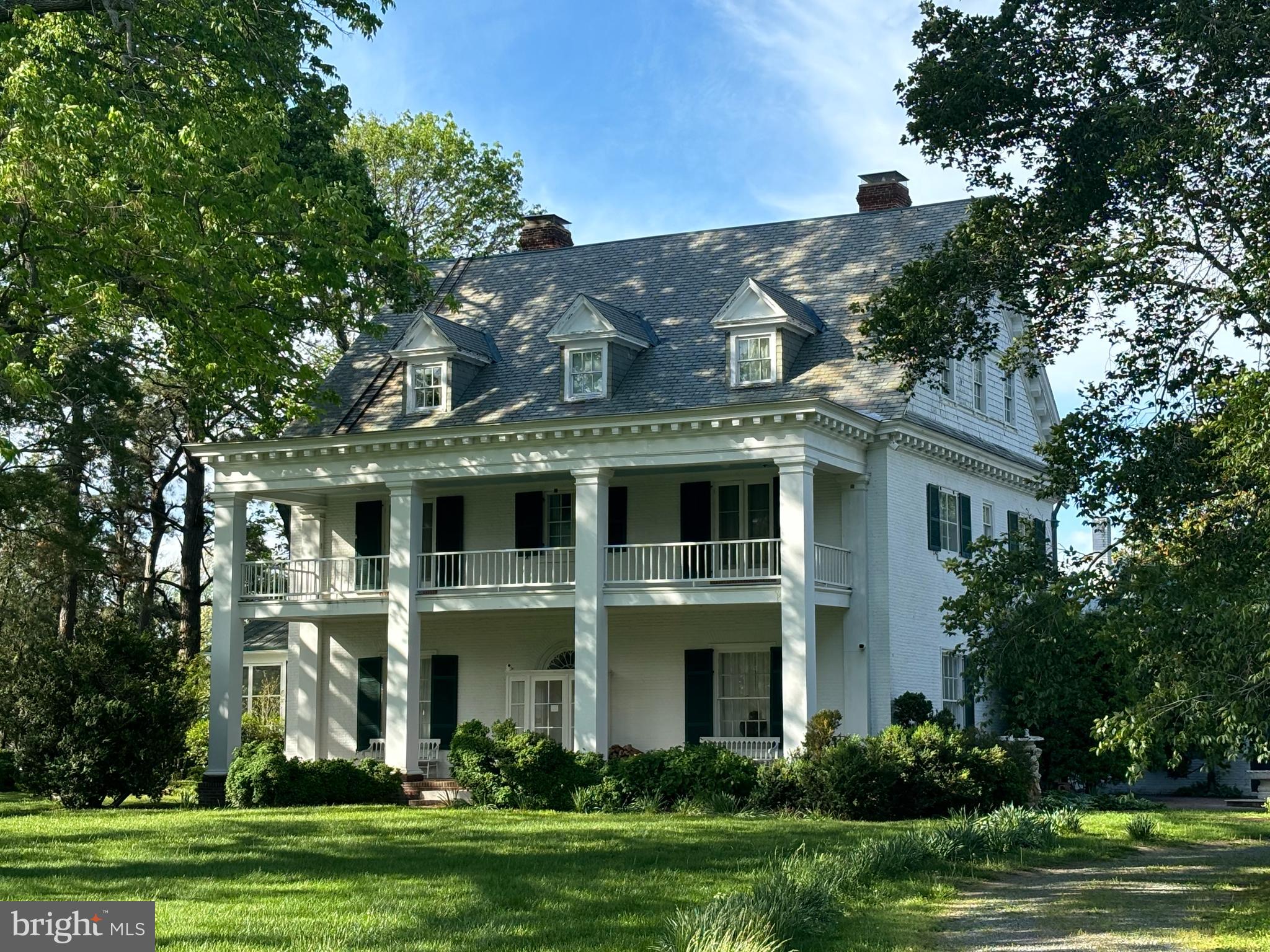 Incredible 300+ acre landmark estate located 5 miles beyond St. Michaels. Over FOUR MILES OF SHORELINE on Eastern Bay, the Miles River and Tilghman Creek. Deep protected anchorage. High land. Sandy beaches. Very livable 10,000+ sq ft home that underwent two-year renovation 2005/2006. 13 ft ceilings on first story and almost10 ft on second story. Formal and informal living areas. Chef's kitchen with vaulted ceiling and excellent light, stainless steel commercial grade appliances, granite countertops. Beautiful draperies throughout the house, and gilded valances in LR. Old wing can serve as caretaker's quarters or home office/conference area or additional BR space. 17 x 16 second story deck off old wing, with outside staircase as well as interior access. Poolside screened porch 17 x 17 with adjacent brick terrace 12 x 26. Front brick floored open porch 12 x 48 with open porch of same size above.
Elevator accesses all three stories and is designed for a wheelchair use.
Primary bedroom suite has walk-in closets, two large bathrooms, and dressing room with fireplace.
Bar off FR has built-ins, two wine refrigerators and an ice machine.
Pool 22 x 44 plus apron and brick wall. Pool is long enough for lap swimming. Loop-lock cover is almost new.
HIGH SPEED FIBEROPTIC INTERNET SERVICE is available from Easton Velocity. The line has just been run. Owner has not yet connected.
Close to the amenities of St. Michaels, with shopping, restaurants and Chesapeake Bay Maritime Museum.
Talbot County has an airport on the northwest edge of Easton.
2700 sq ft caretaker's/guest house remodeled 2004/2005. 9.5 ft ceilings; 15 x 6 foyer; 17x 12 eat-in K;
23' x 19' LR with f/p and built in bookcases; 16 ft sq screened porch with great water view;; half bath.; first floor BR 19 x 13 with f/p and en-suite bath; 2d story has 17x 13 BR with fireplace and en-suite bath, 15 x 13 sitting room, 15 x 14 BR. full bath. "B.A.T" (best available technology) septic system new in 2025. Guest house roof less than two years old. Flower cutting beds, vegetable garden and orchard.
Art studio (16 ft square) on high ground close to Tilghman Creek.
Extensive barns and sheds, including a barn with 5 stalls, tack room and hayloft.
Horse caretaker's apartment near barns.
Incredible camellias, flowering trees, Spring bulbs.
Woods on Tilghman Point is believed to be "virgin forest".
Rich Neck Manor is Talbot County's earliest land grant (1649/1651), The main block of the house was built for Samuel Harrison ca. 1824, Original pine floors, late Federal paneled doors and surrounds, elegant three-story staircase, mantelpieces, etc. The brick dairy (12 x 22) is an architectural "folly" built by Harrison, now used as a chapel. Attached to the Harrison house is a ca. 1740 gambrel-roofed brick kitchen (16 x 36) dating to the days of Matthew Tilghman Ward, while the brick smokehouse (20 x 20), and caretaker/guest house date to ca 1790. Rich Neck Manor was also the home of Revolutionary War patriot Matthew Tilghman. See attachments for history.
This property is protected by a land conservation easement and by a MHT historical easement (see documents attached to this listing). The easement holders are helpful with advice and share their knowledge and experience.
Hunting is outstanding on this property and the hunting rights are available to buyer. Fishing is unsurpassed, and the Miles River crabs are said to be the largest, heaviest crabs on the Shore.
WATER DEPTH: the deepwater harbor is on Tilghman Creek. The "dock" is next to the art studio and consists of a bulkheaded and backfilled area with pilings and slips. It is believed that this area was dredged, but the current depth is uncertain. There is an electronic boat lift here. It has been suggested that the new owner should construct a pier perpendicular to the shore, thereby securing very deep water. The mooring belongs to this property and according to chart has 16 ft mlw.
Available partly furnished.