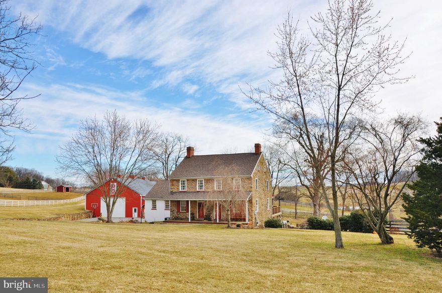 Nestled in the rolling hills of Seven Valleys, PA, welcome to 5868 Glatefelters Station Road. This historic early 19th century Farm home is beautifully set on 25 plus acres in Southern York County. An Equestrian retreat, the gorgeous stone house with 5 bedrooms, 2 full bathrooms, 2 half bathrooms, and over 3,000 sq. feet of renovated living space, offers country living with modern day conveniences. The owner of this exquisite home has lovingly preserved the historic feel of the farmhouse and grounds but has also added many modern amenities that we have come to expect today.  Entering the home on the 1st floor, you are welcomed into a cozy sitting room with a stone, floor to ceiling fireplace with a woodstove insert and natural wood floors. The adjacent great room, is a wonderful place to relax and unwind with a decorative stone fireplace, wide plank floors, sitting area for conversation, reading or watching TV and a dining area. Moving straight back from the entryway sitting room, is the two-story gourmet kitchen demonstrating the perfect blend of historic and modern design with rustic exposed ceiling beams, brick backsplash, farmhouse sink, professional grade appliances including a six-burner stove and double wall ovens, granite topped island with bar/prep sink, large windows, ceiling fans and heated tile flooring, plus room for a large kitchen table. The hallway off the kitchen features multiple closets for your pantry items and other storage needs.  Also, on the main floor is the primary suite with plenty of closet space, extra deep windowsills, and a private bath with a large walk-in glass shower and antique style basin sink. Additional rooms on the first floor include a powder room and laundry room with lots of cabinet space and a large sink.  The 2nd level offers a grand view of the kitchen below, boasting 3 more bedrooms and a full bath with 2 sinks, tiled shower, heated tile flooring and tasteful lighting and fixtures. Adding even more living space to this amazing home is the finished lower level with accents of stone wall, brick and stamped concrete flooring, exposed beams, and wide window ledges.  Included on this floor is an office, exercise room, work room, large family room with heated flooring, bedroom, powder room and more storage space. From this level, you can walk out to the covered patio and take in the amazing view of the pond and surrounding grounds.  A horse lover’s dream, the farm has a total of 19 horse stalls, a lighted outdoor arena, a 90' x200" indoor riding area (built by B & D Builders) with dustless footing, several run-in sheds, a bank barn with auto heated waterers, smaller barn with water and electric and an automatic fly spray control system, tack shop and multiple pastures.  Other out buildings include a corn crib with electric, smoke house, spring house, garage and bank barn with fuel shed.  Along with many more unique features, this home has so much to offer. A dream home in immaculate condition, with gorgeous sunrises and sunsets and picturesque country views, this property is a rare find. Make your appointment today to see this one-of-a-kind opportunity for yourself!