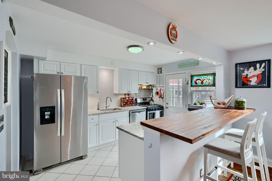 This well appointed porch front home in an established Catonsville neighborhood showcases tons of original charm accented by modern day amenities. The home offers an attached garage, plenty of rear parking & small  yard. Tucked away yet only 1/2 mile from 695 Beltway with easy access to all Catonsville has to offer! Owner has updated this 1939  home with modern amenities while maintaining the timeless old-world charm. Gorgeous hardwood floors are showcased on the main level, stairs  & upper level hallway. The main floor features spacious, well-proportioned rooms ideal for both everyday living & entertaining. The generously sized living room accented with a bay window opens to a  dining area with adjacent kitchen. The kitchen boasts granite counters, decorative backsplash,  tile floor, stainless appliances, updated white cabinetry, loads of counter space & wood island overhang. Convenient access to a small deck is located off the kitchen... a great place for grilling or enjoying a morning coffee. The upper level hosts  three comfortable bedrooms accompanied by a nicely updated full bath with large linen closet. Pull down attic is an additional storage opportunity. The lower level has a multi purpose room/possible 4th bedroom, full bathroom along  with a bump out nook currently used as an office.  A utility room houses the laundry & systems and  provides access to rear yard & attached garage.  Seller offering a 1 Year Seller paid home warranty. Updates/Improvements since 2019: Kitchen: appliances, countertops, sink, backsplash, undercabinet lighting; Bathrooms refreshed;  Newer Washer; Refinished hardwood on stairs /hallway; AC & Boiler recently evaluated and fully serviced. Roof tune ups.