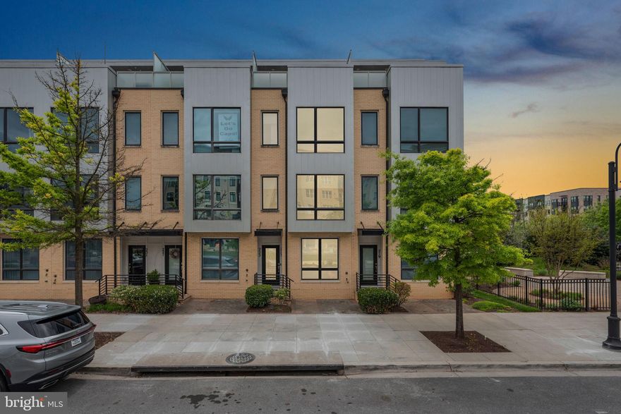 The contemporary townhome you have been waiting for offering rare opulence mixed with superb convenience sited in one of the most coveted locations in Downtown Crown is now available. This stainless steel and fiberboard sided Pulte built 3 Bedroom 3 Full and 2 Half Bath Townhome has all the bells and whistles and what's more is that it has NEVER BEEN LIVED IN - the owner lightly used a few rooms as office space so the next owner is essentially moving into a NEW HOME in the center of everything. The rear of the home backs to the conservancy area, offering serene privacy and views of the trees and creek from the rear deck and master bedroom, while the front of the home faces the Downton Crown main square with green space, rows of restaurants and shops. Enjoy taking in the summer concert series on the Downtown Crown Stage from the best view in the area from the comfort of your own private roof top deck. High ceilings, oversize windows, updated baths, and beautiful hardwood floors grace every level of the home. A stunning gourmet Kitchen boasts quartzite countertops, pantry, a custom backsplash, gorgeous wood cabinetry, recessed and under-cabinet lighting, and top of the line stainless appliances including a gas stove with griddle by KitchenAid. One of a handful of homes with a private entry stoop, one is welcomed to the entry level through a glass door with custom glazing. This level offers a large entertaining room or office, a powder room, mudroom with custom built-in storage, deep coat closet,  custom shade, and access to the super deep garage with dual storage rooms including a rare custom fully secure storage room. The main level is open concept and features areas for Living Room with wall TV hook ups, Dining area, and Large kitchen with doors leading to an expansive deck and views to the trees. The next level boasts the Owner's Suite with a bump-out extension, walk-in closet, luxurious shower and dual sink vanity, separate laundry room, and the 2nd guest bedroom with en suite bath. The top floor offers a large family room with a dual sided gas fireplace, a large 3rd bedroom with ample closet space, hall bath, and access to the spacious rooftop deck. The condition is perfection. Everything is essentially new. The location is unmatched! Welcome Home!!!