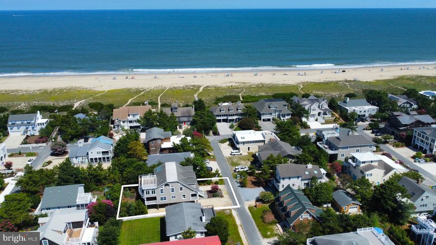 Just three homes from the oceanfront, this coveted Sussex Shores retreat puts you steps from a private, life-guarded beach and a short stroll to the charm of downtown Bethany. Take the elevator to the light-filled top level, where a dramatic great room opens to a sunroom, spacious deck, and rooftop perch for sunrises over the ocean’s horizon and sunsets on the Salt Pond. The over-sized kitchen, with its grand island, stainless steel appliances, two dishwashers, beverage fridge, and tiled backsplash, is designed for gathering with friends and family after a day on the beach. A serene primary suite and private den that easily couples as addition sleeping space complete the main floor. The middle floor offers a second family room, four guest bedrooms, and front and rear porches. On the ground level, you’ll find two outdoor showers, ample storage, laundry, covered parking plus a long driveway for additional guests.  Freshly painted and offered furnished, this coastal retreat is ready to enjoy. Rarely are homes available for sale in the community of Sussex Shores, one of the most desirable locations on the Delaware coast.
