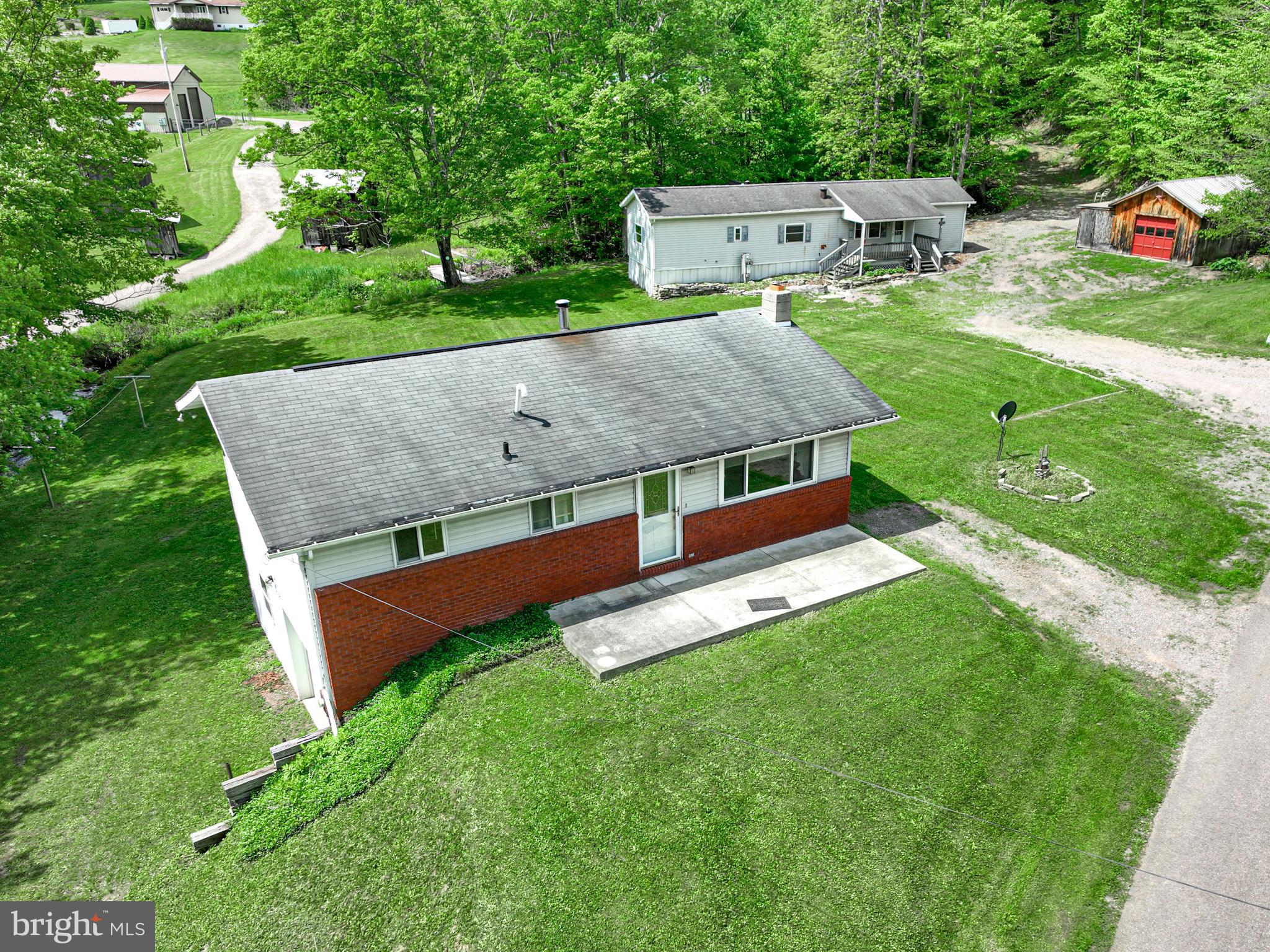 This property boasts two distinct homes situated on a sprawling 2.2 acres, offering a unique opportunity for multi-generational living or a rental investment.
First, explore the charming 3-bedroom, 2-bath house featuring a spacious layout perfect for modern living. The home includes a basement garage , providing convenient access and ample storage for all your belongings. Step outside to discover the beauty that surrounds you, with a creek bordering the property , creating a peaceful natural ambiance that will be your sanctuary.
Additionally, the property features a 3-bedroom, 1-bath single wide , ideal as a guest home, office, or rental opportunity. Both residences offer character and functionality, ensuring versatility for your needs.
An additional garage on the property further enhances this home's appeal, perfect for hobbyists or extra storage. This picturesque setting, combined with the potential for various uses, makes this property a true gem.
Don't miss your chance to own this unique property that perfectly blends comfort, space, and the beauty of nature! Schedule a viewing today and imagine the endless possibilities that await you.