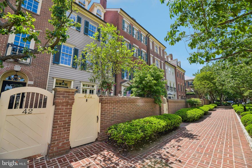 A Harborside waterfront townhouse, solidly built to last by local, renowned Abramson Properties, doesn’t just offer a place to live—it offers an exclusive, serene escape and lifestyle.  Nestled within one of Old Town’s most prestigious waterfront enclaves, this well-built Georgian style residence provides a private retreat paired with a remarkable location that places you at the center of everything exceptional. Just steps from Old Town’s breathtaking waterfront, scenic parks, boutique shops, acclaimed restaurants, historic homes & museums,  easy access to Washington, DC, Reagan Airport, and major commuter routes, you are conveniently surrounded by everything that makes this area so highly desirable.

From the moment you step through the wooden gate, a private, meditative garden welcomes you with lush trees, colorful, flowering plants, and the soft sound of trickling water running through a stone fountain resembling a private, hidden oasis. Inside the well-constructed, traditional home tells its story across four thoughtfully designed levels, each filled with many windows, well-maintained hardwood floors, refined details, and wonderful views of the beautifully landscaped garden retreat. 

The open living and dining room spaces are inviting, yet elegant, made for intimate dinners, quiet reflection, working-studying, or entertaining. The layout of the home creates a sense of warmth, openness, and inspiration, with scenic views of the city & neighborhood from both the main and top levels. Natural light pours through the windows highlighting crown ceiling moldings, appealing window treatments & finishes, and a flowing layout that feels both comfortable and uplifting. An enclosed, built-in classic wet bar along with two marble framed fireplaces add both warmth and character that makes the home feel as memorable as it is livable.  

This charming kitchen has been beautifully updated with a new 2025 Miele stainless steel refrigerator, new backsplash and water filter for the kitchen sink, EcoWater Water Softner for the entire home, and a custom California closet expanded for kitchen pantry storage. Additional improvements—including fresh interior and exterior paint, a new Durolast roof membrane, a new skylight, and a sturdy front storm door—all reflect the kind of careful upkeep and thoughtful investment. This means the hard work has already been done for you and what remains is the joy of moving into a home that has been cared for with intention.  

What makes this exceptional, waterfront townhome in the coveted community so compelling is not just how beautifully it lives, but how distinctive homes such as this one rarely become available. Not to mention, that once you become an owner at Harborside, you have the unique option to purchase or rent your very own boat slip or boat slips!  With 1,692 square feet, spacious kitchen/living/dining room area, two bedrooms, three bathrooms, and a two-car garage, this remarkable home delivers both comfort, space, and low-maintenance convenience that makes everyday living feel comfortable and effortless.

More than a residence, this Harborside waterfront home is a sensory experience. It offers an immediate, visceral connection to the water—a sanctuary of quiet luxury and an enduring friendly community that remains elusive in today’s market. If you have been waiting for a home that resonates with your true standard of living, this is your invitation to finally inhabit the life you have envisioned.