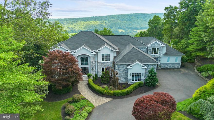 Perched above the hills of Northeastern, PA in Woodridge, this custom estate offers extraordinary year-round views and luxury amenities. 5BR/5BA, 5,700+ sq. ft. plus 1,700 sq. ft. finished walk-out lower level with second kitchen, family room, full gym, and bath. Guest suite, recreation room with bar, sunroom, stunning pool & decking, pickleball court. Privacy, elegance, and lifestyle in one.