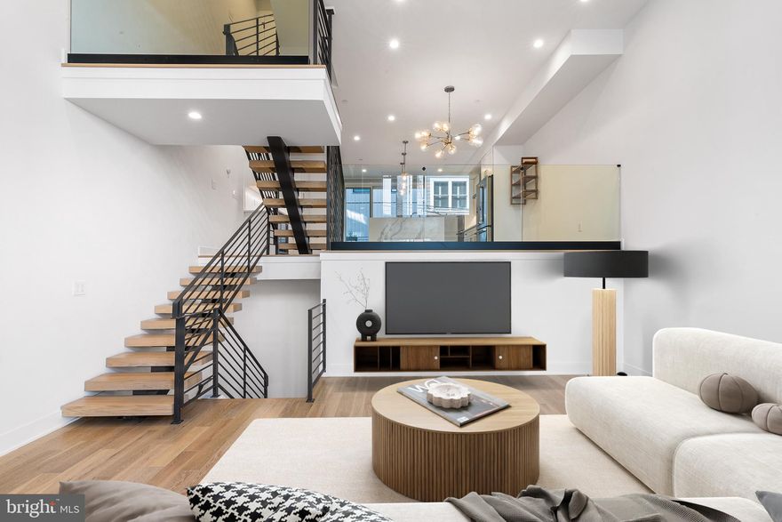 Situated in the prime Graduate Hospital neighborhood, 2214 League Street is a 20’ wide newly-built townhouse featuring 2,700 square feet of contemporary and well-designed living space with 2 CAR GARAGE PARKING and 2 outdoor areas. Step up from the sidewalk and enter into the impressive front living room. Here, soaring ceilings and floating stairs frame the double-height room which is complete with light wood flooring and a front wall of oversized windows. The open first level enjoys daylight from two exposures with motorized shades for ease of operation. Sharing the split first level with the living room, the gourmet kitchen floats just above and offers a defined space of its own. The kitchen is marked by its double-deep waterfall island with globe pendants, gray and white cabinetry with chrome hardware, quartz countertops, and stainless steel appliances. Kitchen appliances include a Wolf gas cooktop, double oven, 3-door refrigerator, dishwasher, built-in microwave, and wine refrigerator. The entertainer of the home will love hosting friends on the cantilevered deck off of the kitchen or in the dining area beneath the sputnik globe chandelier. A convenient powder room completes the first level. Steps above, two of the three bedrooms are situated on the second floor, each with gracious closet space and oversized windows. These bedrooms share a hall bathroom outfitted with dual sinks, lovely gray and white tiling, a tub/shower, and radiant flooring. A laundry room with a sink, built-in cabinetry, and LG washer / dryer completes the second level. A wet bar with a wine refrigerator greets at the third-floor landing. Here, outside of the primary suite, the wet bar and nearby powder room are conveniently set on the way to the roof deck. The remainder of the third floor is devoted to the primary suite. With its king-sized bedroom, walk-in closet with Elfa shelving and drawers, and spa-like bathroom, the primary suite is the perfect place to recharge after a busy day in the city. The en-suite bathroom is there to impress, with its elegant gray and white tiling, free-standing soaking tub, oversized glass-framed shower, wide vanity with dual sinks, and radiant flooring. Outside the primary suite, the upper stairs lead to the green roof deck which features perimeter lighting, a water spigot, electrical outlets, and, of course, incredible city views! Outdoor furnishings are included with this lease for the resident’s enjoyment. Before heading on your way, be sure to step down to the attached 2-CAR GARAGE with EV outlet as well as the finished basement below! The finished basement offers additional space for an at-home office, media room, or gym. Situated between numerous cafes, restaurants, and shops, and with quick access to UPenn, CHOP, and HUP, the central location is one of the countless amenities that this property has to offer. 2214 League Street is a quick walk to neighborhood favorites like Ultimo Coffee, The Sidecar, Small Oven Pastry Shop, and Dock Side Brewery. Grocers like Sprouts, South Square Market, and Heirloom Market all call the Graduate Hospital neighborhood home. Retail stores like Target, CVS, Wawa, Fine Wine & Good Spirits, Starbucks, and PetSmart can also be found a quick walk from the property. Schedule your tour today!