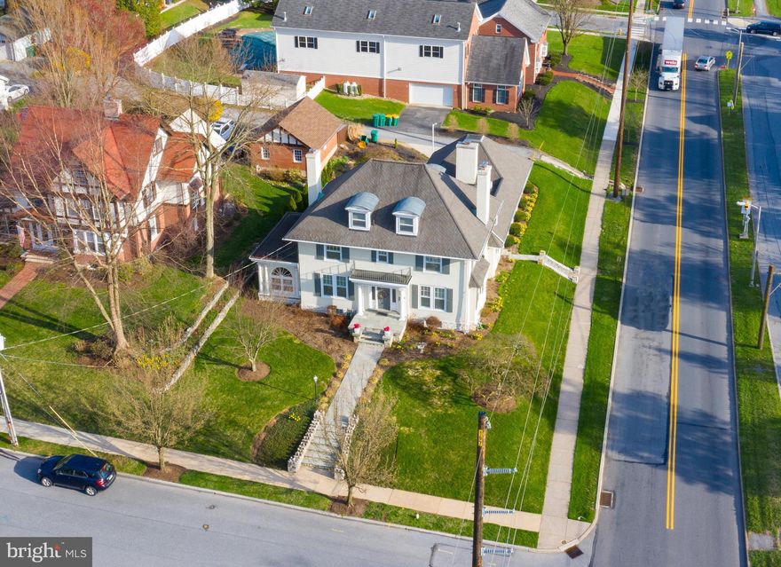 Located in the heart of Hershey, this immaculate historical preservation award winning home boasts 4 bedrooms, 3.5 baths, and over 5,000 square feet of living space. The home was originally built by Milton Hershey and is known locally as the Postmaster House. An eye-catching design was incorporated to this corner property made out of 2 ft thick white stone, giving it the glamour and prestige that it has today. Both the interior and exterior of the house have been restored close to their original looks of 1914 when it was built. As soon as you step into this 2.5 story beauty, you'll notice a bright and open atmosphere from vivid transom windows to gleaming hardwood floors. Highlighting the main floor is a breathtaking all-seasons sunroom with tile flooring, exposed beams, distinct shiplap, and walls of windows for natural light to bathe the room. It truly is the perfect room for relaxing year-round. The adjacent family room makes for a great entertainment area with built ins, sliding door to the sunroom, warm gas fireplace, and convenient access to the 2-car garage. Past the family room is a gorgeous kitchen complete with white cabinetry, tile backsplash, center island, built in appliances, electric cooktop/range, and even a breakfast area overlooking a scenic stained-glass window. For more formal occasions, the separate dining room is just the place for gatherings and holiday get-togethers. In times like today, a comfortable yet private area to work from home is a must have. Look no further than the quiet study just off the living room, featuring beautiful French doors, a double-sided fireplace, exposed beams, and built ins for easy storage. Completing the first floor is a convenient laundry room and half bath. The second floor of this already immaculate home boasts 2 full baths and 3 spacious bedrooms, each with plenty of closet space. A pair of staircases can be found to the second floor, one in the kitchen and one by the foyer. Right before the stairs to the third floor is a door with convenient access to a rooftop terrace with unlimited possibilities. The secluded third floor is home to a 4th bedroom that can also be used as an owner’s suite, featuring a private bath and 2 sizable walk-in closets. Additional living space can be found in the lower level which offers a spacious recreation area, currently being used as a home gym, but could easily be a game room or even a home theater. The lower level also includes a personal sauna, perfect for relaxing after a workout. The exterior offers a private brick patio in the backyard that is well shaded, making it an ideal location for summer gatherings. This property offers a truly rare opportunity at owning a part of Hershey history! From the soaring ceilings to the astounding pathway to enter the home, this property is rightfully one-of-a-kind. It is just minutes from Hershey Park, Tanger Outlets, Hershey Elementary, Middle, and High School, but offers an easy commute to Harrisburg, York, and Lancaster. Schedule your showing today for this historic home in the heart of Hershey!