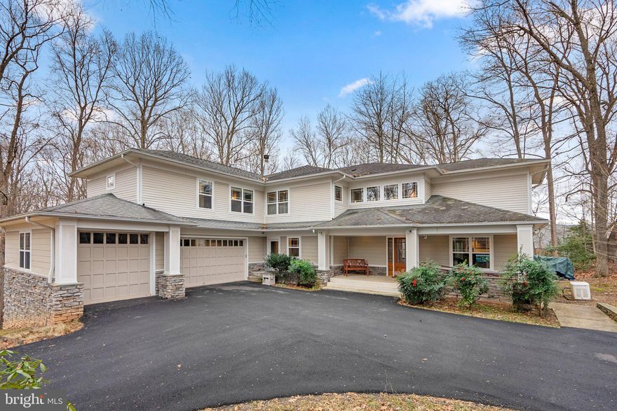 Welcome to this exceptional residence, where luxury and sophistication converge across three meticulously designed levels. The main level beckons with a grand two-story foyer adorned with picture windows, hardwood floors, and an elevator for convenient access. The enchanting living room/office boasts a gas-burning fireplace, custom built-ins, and dual access to a private screened-in porch with Trex decking. The formal dining room features picture windows, a custom chandelier, and French door access to the porch. The chef's kitchen is a culinary haven with cherry custom cabinetry, commercial-grade appliances, and picturesque views of a serene pond. A dramatic family room with a wood-burning fireplace and cherry entertainment center completes the main level.

Ascend to the second level, where the primary bedroom suite exudes opulence with a gas-burning fireplace, wood ceiling, and a walk-in dressing room. The luxury primary bathroom is adorned with Carrera marble countertops, a full shower with designer hardware, and decorative mirrors. Additional bedrooms feature sun-filled windows, custom closets, and access to well-appointed bathrooms. An elevator provides convenient access to all levels.

The lower level is an entertainment haven, featuring an expansive recreation room with a built-in theater, game room with a wet bar, and walkout access to a pond. A full bathroom, storage/utility rooms, and a workshop complete this level. Special amenities include hardwood floors, 3-zone HVAC, and a pond with goldfish and lily pads. Elevate your living experience in this extraordinary home, where every detail has been thoughtfully crafted for comfort and luxury.