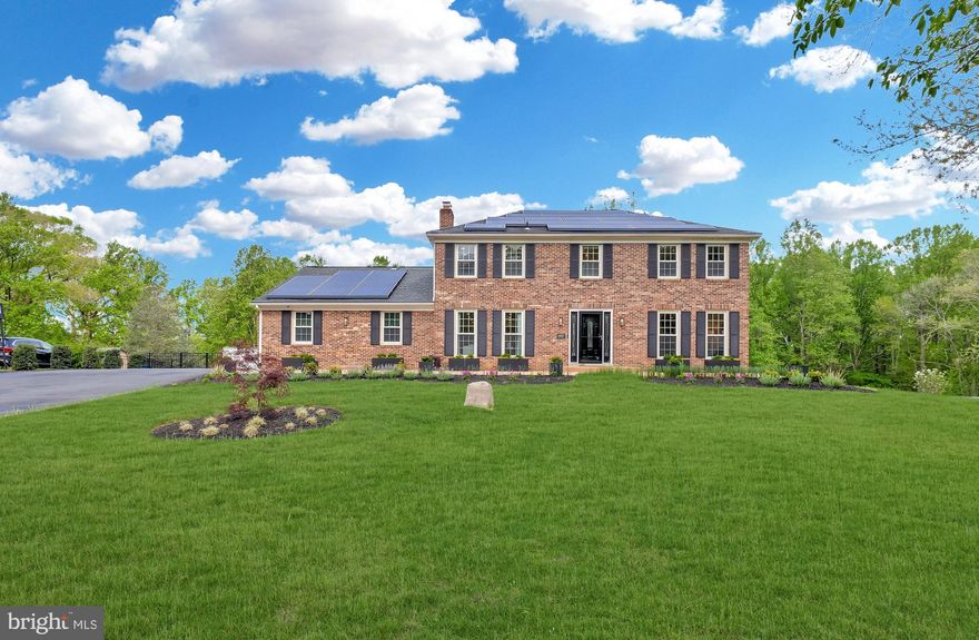 Tucked away in the coveted Farmlands community in North Potomac, this stunning brick colonial is nestled on over 2.2 picturesque acres, bordered by Muddy Branch Park and surrounded by mature trees — offering unmatched space, privacy, and convenience- just  30 minutes from Washington, D.C. Approaching the home feels like a scene from a film, with streets lined by blooming cherry blossoms guiding you to a newly expanded driveway and stamped concrete front patio, offering elegant curb appeal and parking for up to 10 cars — perfect for family, friends, and celebrations. 

Step inside to find a fully renovated interior, where no detail has been overlooked. The main level features a spacious formal living room and dining room, anchored by a spectacular, designer​ kitchen with espresso maple cabinetry, ​2 large quartz waterfall islands, stainless steel appliances, and breakfast bar seating.  Large windows fill the space with natural light and frame serene backyard views, making the kitchen as inspiring as it is functional. The adjacent family room centers around a wood-burning fireplace with luxurious Versace tiles surround — a unique statement of style and warmth.​  From here, step out to the stylish and serene deck, featuring sleek glass panel railings and soft LED post lighting, where you can enjoy every season with a heated endless pool or a quiet evening under the stars, framed by the peaceful silhouette of mature trees. 

Upstairs, the expansive primary suite spans the rear of the home and overlooks the lush backyard. It includes his-and-her closets, one of which is a large walk-in with custom organizers, and a spa-like en suite bath with frameless glass shower, custom tilework, and a double-sink vanity. 3 additional ​ good- sized bedrooms and a remodeled hall bath complete the upper level.

The fully finished walk-out basement offers flexible living with a large rec room, additional bedroom​/home office, ​a full bath, cedar closet, and full-size windows — ideal for casual entertaining, guest space, or an in-law setup. A sliding door opens to a lower-level brick patio and leads straight out to the beautifully landscaped, fenced backyard​, where you'll find a dedicated garden area, greenhouse, and wide open lawn perfect for play or peaceful enjoyment. 

Additional upgrades and features include: New siding (2022), New well pump, Newer water heater, Garage with epoxy floors, dedicated A/C, and EV charging outlets, Solar energy prepaid through 2034 — maintenance-free​ & cost-saving​; Recessed lighting and solid wood doors throughout the home.  

Located in the highly rated Wootton High School district, this home is just minutes from Potomac Oak Center, Trader Joe’s, Kentlands, and a wide range of shopping, dining, and recreation options. With RE2 zoning and no HOA restrictions, the property offers exceptional flexibility for future plans or lifestyle needs. Enjoy direct access to Muddy Branch Trail right from your backyard — a scenic greenway that connects to the C&O Canal, kayak launches, golf courses, equestrian centers, and Seneca Creek State Park. Whether you're seeking space to grow, a peaceful setting for family life, or a luxurious retreat close to nature and city life — this home delivers it all.