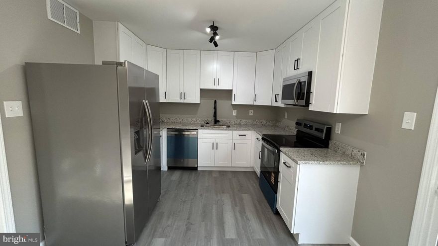 3-level spacious townhome has a large updated kitchen with 42-inch white shaker cabinets, all new appliances and granite countertop. New windows and sliding patio door, opens to a spacious deck and a level backyard with shed. The entire main floor and basement are covered by new vinyl flooring. Upstairs 3 bedrooms with new carpets. Entire house has been painted with a neutral color. Bathrooms tastefully renovated with new tiles, tubs and vanities. 2 Assigned parking spaces right in front. This one shows like a model.