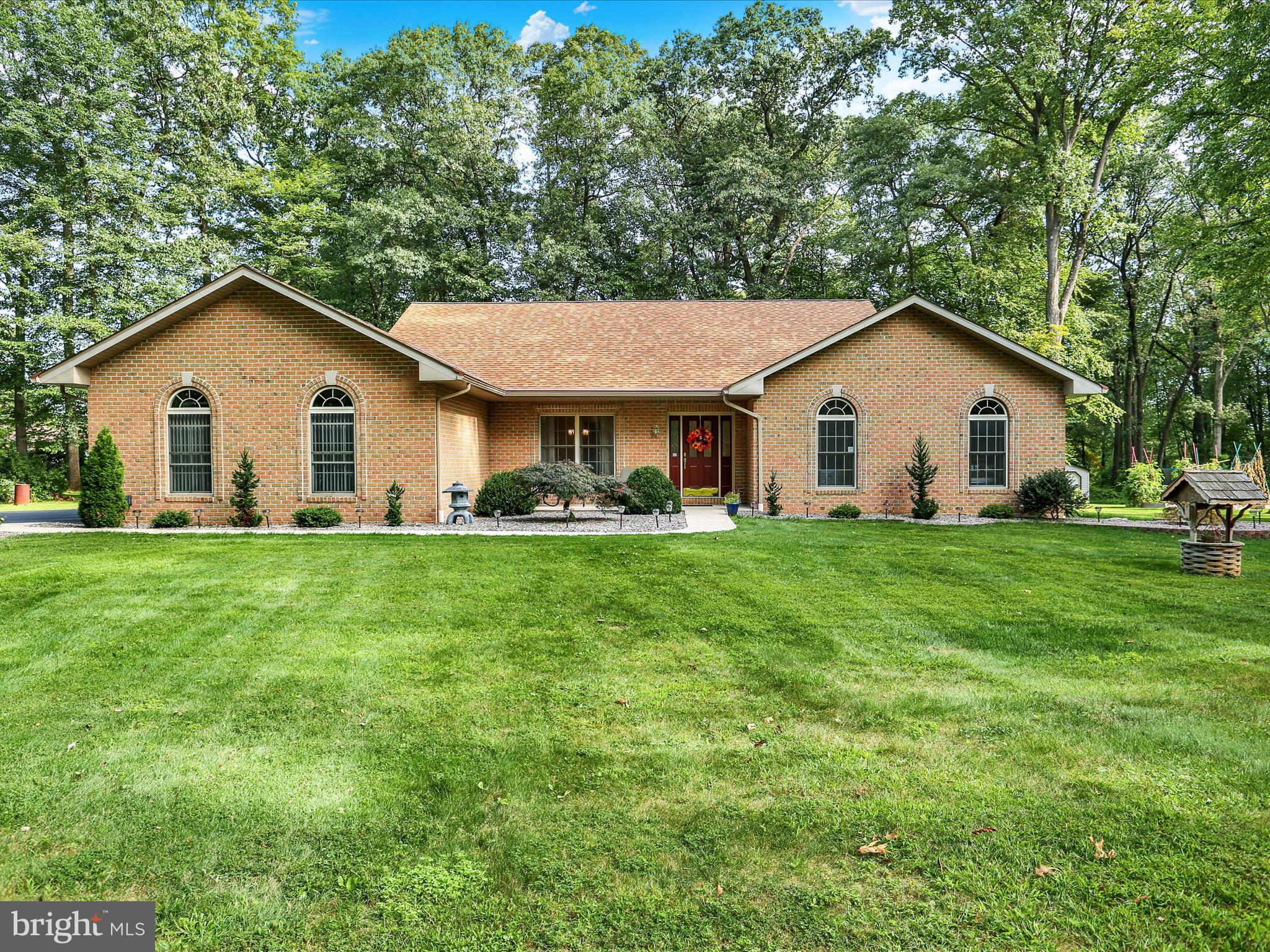 Immaculate from top to bottom! Pride of Ownership is evident from the moment you pull up to this property. Situated on a tree lined, 1+ acre lot in Oley School District, this home is in MOVE-IN ready condition. As you enter in the front door, you will instantly notice the hardwood floors that lead you from the foyer through most of the main level. To the left is the dining room with an accented tray ceiling - a GREAT spot for those special occasions! From here, the open floor plan takes you right back into the living room. The cathedral ceilings, large windows and multi-sided fireplace make this space one you will be spending a lot of your time in! From here, the kitchen is next. With an eat-in area, large island, cooktop, wall oven and PLENTY of cabinet and counter space - this area will make mealtime easy and fun! Now back to the bedrooms. First is the primary suite - with a large bedroom, walk in closet and full bath you will feel like everyday is a vacation! There are also TWO more nicely sized bedrooms that share a full bath in the hallway. Completing the main level is a laundry room and half bath. As you head down to the lower level, you get an idea for the size of this home. There is a family room/rec room with a pool table and bar as well as a walk in storage closet on the finished side. The unfinished side has the updated, propane mechanicals, a large storage room AND a workshop - along with BILCO door access into the back yard. Speaking of the yard.....the outside of this property has beautiful landscaping, mature trees, a front porch, back patio and an OVERSIZED two car garage. This home is a MUST SEE! Don't delay, please call to schedule your showing today!