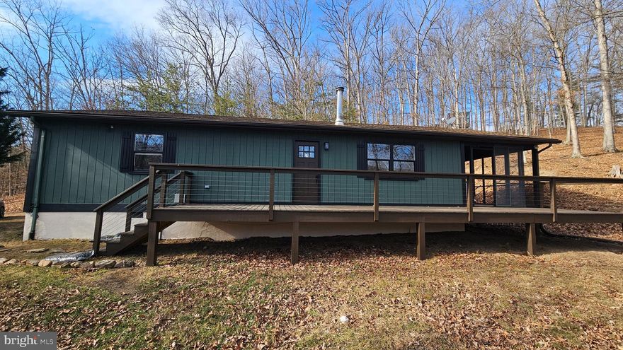 This totally updated 2 bedroom, 1 bath cabin is nestled in the woods within the desired, gated river front community of River Ridge located in Morgan County, WV.  Enjoy the winter southwest views of the  mountains and local wildlife on your large screened in porch. The community river front area offers a bath house, area to leave your canoe, kayaks, or john boats and picnic area along the Cacapon River (known as the 3rd cleanest river on the east coast). The cabin has been upgraded with new flooring, appliances, lighting fixtures, kitchen cabinets, new countertops, rescreened side deck and freshly painted inside and out. Make this your getaway or primary residence.  No short term rentals. Owner is a licensed WV real estate agent.