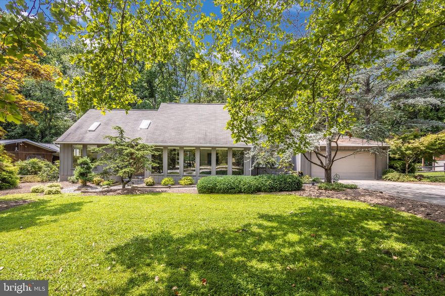 Fabulous Contemporary with Mid-Century Modern Lines!  Situated in the sought after Hobbit's Glen area, this attractive home has the open floor plan of today with plenty of private spaces for Zoom meetings, work or study.  Grand windows saturate the home with natural light from the pegged wood floors to the soaring ceilings. Two story double sided stone fireplace in the great room, separate family room off of the kitchen, dining room, 2 bedrooms and 1.5 baths on the main level.  Open staircase leads to upper level  with primary bedroom  improved with generous closets with custom built ins.   Primary bath with  double vanity. Fourth bedroom or office +++ on upper level. Lower level has been fully finished and has many applications ranging from teen suite, in law suite, complete home business/office. Bedroom/office space, open rec area, full bath and large sliders to walk out level.  And the rear yard... EXHALE and enjoy the peace and quiet of your wooded oasis. Fabulous landscaping, walkways patio and deck to enjoy this special private space that can be hard to come by in Columbia.  Plenty of parking on private section of Harper's Farm Road and in your own driveway.