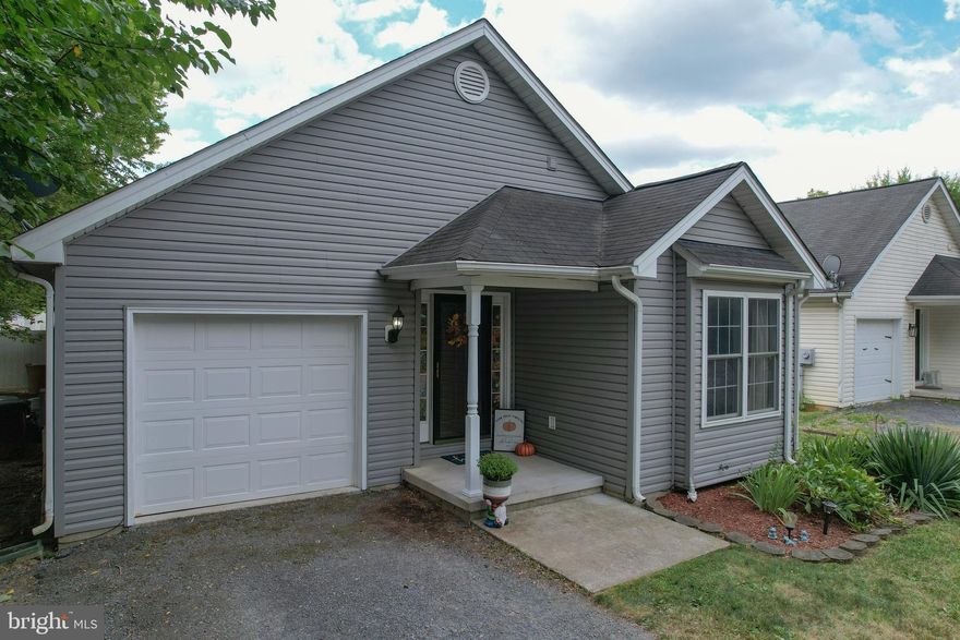 Let’s own a home, shall we? If you’ve been debating rent vs. buy, this is your chance to own for less than rent and start building equity. Welcome to this charming 3 Bedroom, 2 Full Bath Ranch-style home in Inwood, WV, perfectly tucked away at the end of a no-thru street for privacy.

Step inside to discover gleaming hardwood floors, cathedral ceilings, and an open-concept living room and kitchen that make everyday living and entertaining seamless. The kitchen flows effortlessly into the living space, keeping you connected while you cook.

The primary suite is generously sized with a walk-in closet and a well-appointed en-suite bath featuring a tub/shower combo. Two additional bedrooms sit at the front of the home, offering privacy for the owner’s suite and versatility for guest rooms, a home office, gym, or flex space.

Practical features shine here: a main-level laundry room with folding space, a sizable one-car garage, and extra driveway parking. Outside, you’ll love the new vinyl privacy fence that surrounds your large backyard—perfect for pets, play, or weekend BBQs.

This turnkey home is move-in ready, and with its location in the heart of Inwood, you’ll enjoy convenient access to commuter routes, schools, shopping, and dining. Don’t miss this opportunity to own an affordable, stylish home in Berkeley County. Schedule your showing today and make 38 Gayton Lane yours!