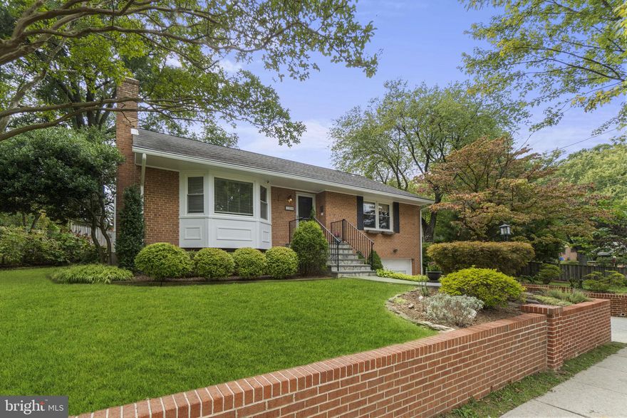 Welcome to 1008 Lanark Way in the South 4 Corners neighborhood of Silver Spring.  This charming raised brick rambler has been meticulously cared for from top to bottom.  The landscaped yard has stunning curb appeal, something blooms year round throughout the front and back yard.  This property has a generous floor plan with over 2,300 combined square feet providing space for comfortable living and entertainment. 
The walkway was replaced in 2016 along with the retaining wall against the driveway.  The main level has hardwood floors that flow throughout.  The living room has a large bay window and a cozy woodburning fireplace.  The main level layout continues to a separate dining room with another bay window with custom build in shelving.  The dining room opens to the kitchen as well as to a 3 seasons Florida room on the back of the home with a sliding door that overlooks the landscaped, peaceful and private backyard.  The kitchen has stainless steel appliances with light wood shaker cabinets, granite countertops, peninsula giving space to eat in the kitchen.  A custom recessed pantry has roll out shelving that can be adjusted for height.  The main level has 2 spacious bedrooms and a full bathroom.  Both bedrooms have closets with organizational systems to maximize space.  Bedroom 1 is currently carpeted with hardwood under the carpet.  Bedroom 2 has been used as a home office with a wonderful and functional layout.  
The finished lower level has been used as a 3rd bedroom and additional living space.  From the current 3rd bedroom space there is a closed vestibule that leads to the garage.  There is a separate walkout to the backyard from the laundry room.  The laundry room has wonderful built in storage and a stunning cedar closet.  
Property notable highlights include driveway retaining wall (2022), HVAC and water heater (2020), Roof and gutter guards (2018), new slate walkway (2016) and so much more.  Situated in a sough after neighborhood, this property offers convenience and sense of community.  South 4 Corners is close to parks, Sligo Trail, schools, downtown Silver Spring, public transportation, 495, Washington DC, Virginia and so much more!