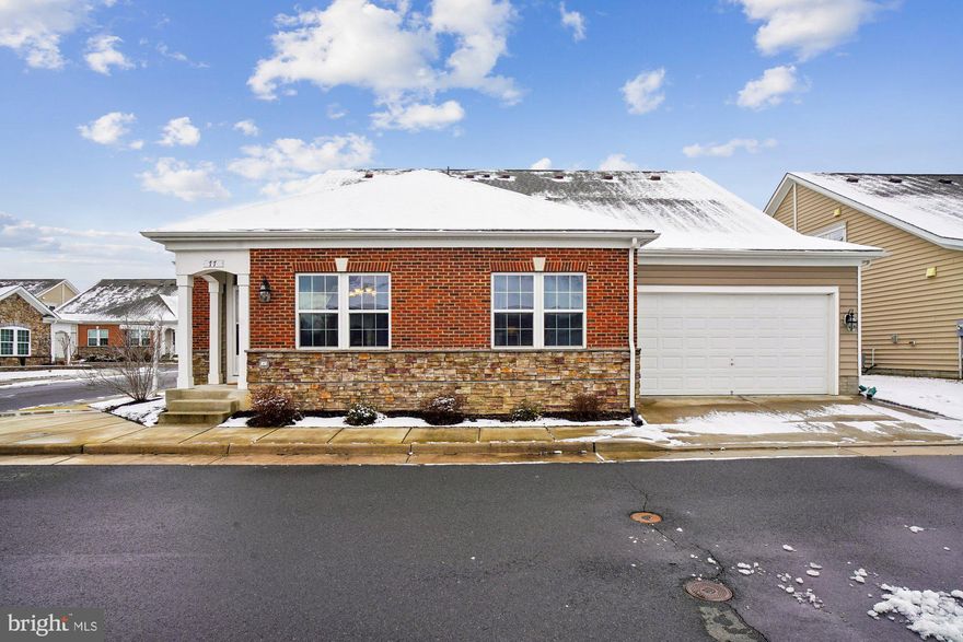 Welcome to this beautifully maintained 3 bedroom, 2.5 bath home in Heritage Highlands, one of Lovettsville's most desirable 55+ communities. This spacious SMART home offers the perfect blend of comfort and convenience for every stage of life. The main level features a generous living area with a cozy fireplace, and gleaming hardwood floors.  A  fully equipped kitchen with granite countertops, stainless steel appliances, and a dining area ideal for gatherings with family and friends. The primary bedroom is also located on the main level and includes a large walk-in closet, beautiful en-suite bath with oversized shower.  Second bedroom and a convenient half bath for guests complete the main level. Upstairs you will find a spacious 3rd bedroom with a full bath, along with a cozy loft area offering extra living space and additional storage. Brand new carpet on the upper level. Two car garage and abundant closet space throughout, providing excellent storage.