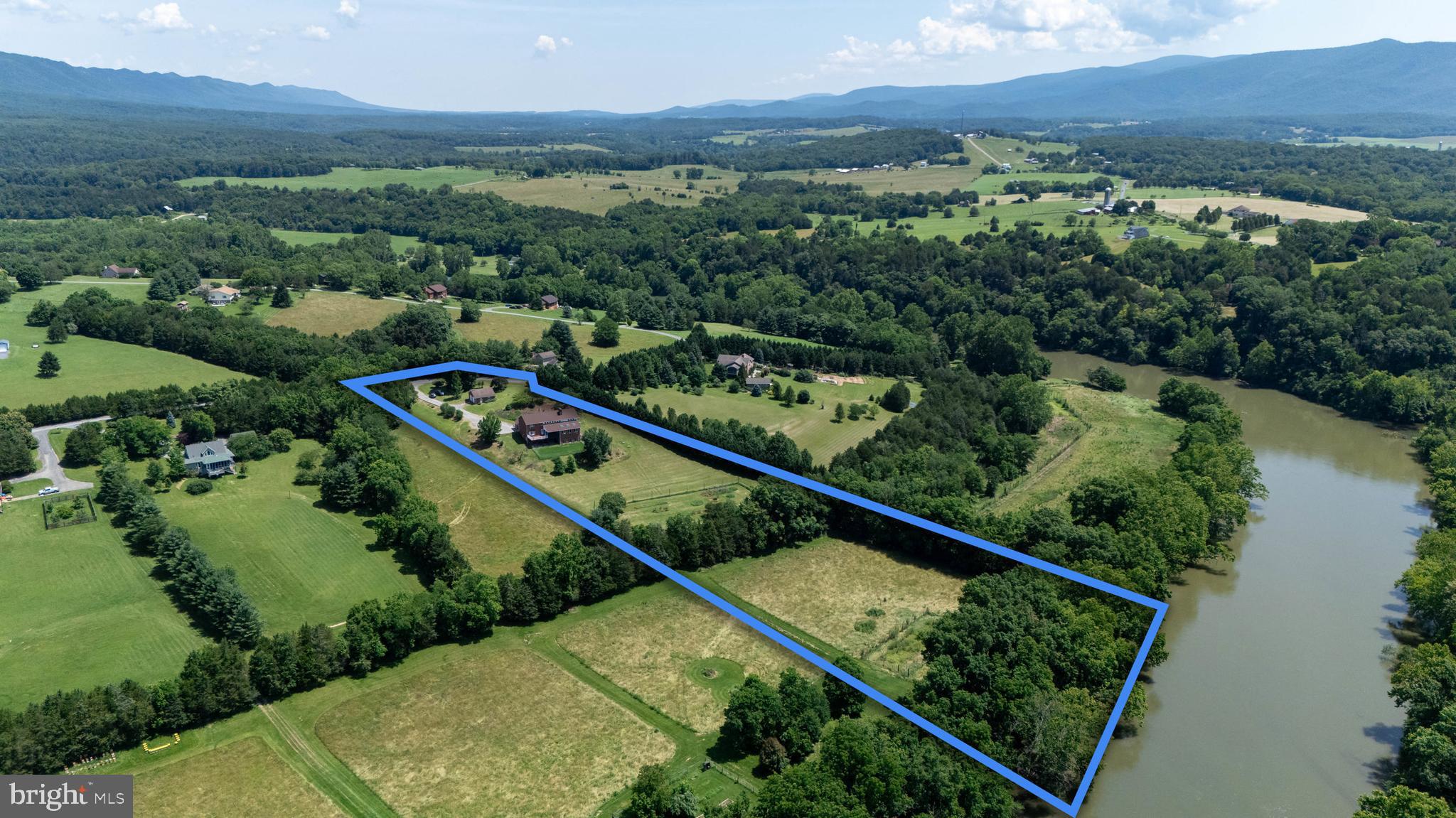 This custom-built brick home with 398 feet of private frontage on the South Fork of the Shenandoah River offers panoramic mountain views and nearly every custom feature you could imagine. Showcasing over 4,700 finished square feet spread across 4 bedrooms and 4.5 bathrooms, this home is one not to be missed. The spacious layout of this home includes a large eat-in kitchen, a separate formal dining room, and a main-level primary suite with an oversized soaking tub and walk-in shower. Connected to the primary bathroom is a private, indoor eight-person hot tub room with skylights—perfect for relaxing year-round while gazing at the stars above. Designed with entertaining in mind the main level’s living area features a built-in bar that is ideal for hosting gatherings. Just off the gourmet kitchen you will find an expansive screened-in porch and a separate grilling deck, perfect for seamless indoor-outdoor living year-round. Venturing upstairs you will find three additional bedrooms, including one bedroom featuring its own gas log fireplace for those cozy evenings, and two full bathrooms! The enormous basement offers endless possibilities with a full bathroom and a dedicated workshop area. Outside, enjoy the fruits of nature from the mature apple, peach, and cherry trees, as well as fresh blueberries, blackberries—and even native Paw Paw trees, which produce unique, tropical-like fruit each season. Do not forget about the two car detached brick garage / workshop containing nearly 800 square feet for all your hobbies / storage needs! With direct, private access to the South Fork of the Shenandoah River, you can enjoy countless hours canoeing, kayaking, tubing, and fishing right from the property—and also take advantage of the community’s private river access a short distance away. This home is located in an HOA which does not allow short-term vacation rentals. Situated just minutes from the Shenandoah National Park, Luray Caverns, and the downtown shops and restaurants of Luray, this property is the perfect combination of comfort, convenience, and natural riverfront beauty. Do not miss your opportunity to own this truly exceptional property.