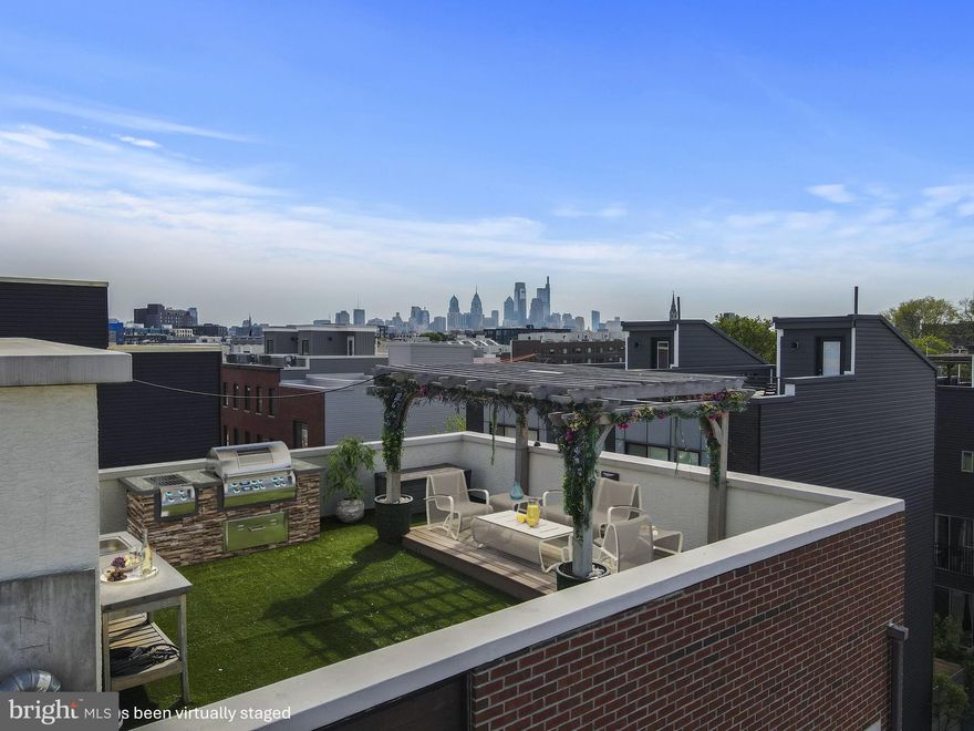 Gorgeous, end-unit townhome located in the heart of Fishtown with a fantastic rooftop entertainment space with skyline views and garage parking! This home has it all! A cheerful entrance invites into this bright and airy home with a lovely family room with striking hardwood floors and recessed lighting.
Head upstairs to the 2nd level where you will find the heart of the home with an open floor plan and an abundance of natural light. A living room/dining area and a stunning kitchen with quartz countertops, subway tile backsplash, 42" soft close cabinets, stainless steel appliances, gas cooking and a farmhouse sink. The huge breakfast bar with pendant lighting, can comfortably accommodate seating for 7 people. Also, conveniently located on this level is a powder room for guests. The 3rd floor includes 2 en suite bedrooms with spacious closets. One of the crown jewels of this home is the finished rooftop with amazing views, a wet bar and pergola. Perfect for entertaining guests and a tranquil place to unwind at the end of the day. The lower level of the home is a wonderful flex space that offers a variety of uses, such as an expansive en suite bedroom, media room, recreation room or a fitness and wellness space. A charming, barn slider door provides access to a large full bathroom with double vanity, a walk-in shower with floor to ceiling tile and glass enclosure. Enjoy the roomy walk-in closet with custom built-ins. The laundry room is also located on this level.  The oversized garage parking with interior access is an invaluable luxury with city living! 

Enjoy all that Fishtown offers with a bustling culinary scene with wonderful restaurants, inviting beer gardens, renowned gastropubs and cafes. Creativity thrives in this neighborhood with eclectic boutiques, galleries, studios and venues such as Johnny Brenda’s. Enjoy fresh, locally sourced produce and ingredients at the esteemed Riverwards Produce Market. So many incredible options within walking distance. Wm. Mulherin’s Sons, Suraya, Kalaya, Laser Wolf, Middle Child Clubhouse, 
La Colombe, Philadelphia Brewing Company, Kensington Quarters, Fishtown Social, Izakaya, Pizza Brain, Frankford Hall, Loco Pez, Cedar Point, Barcade and many more fantastic places to indulge. Enjoy nearby parks such as Palmer Park. Easily accessible to Center City and access to SEPTA's Market-Frankford El line, I-95, and Delaware Avenue.