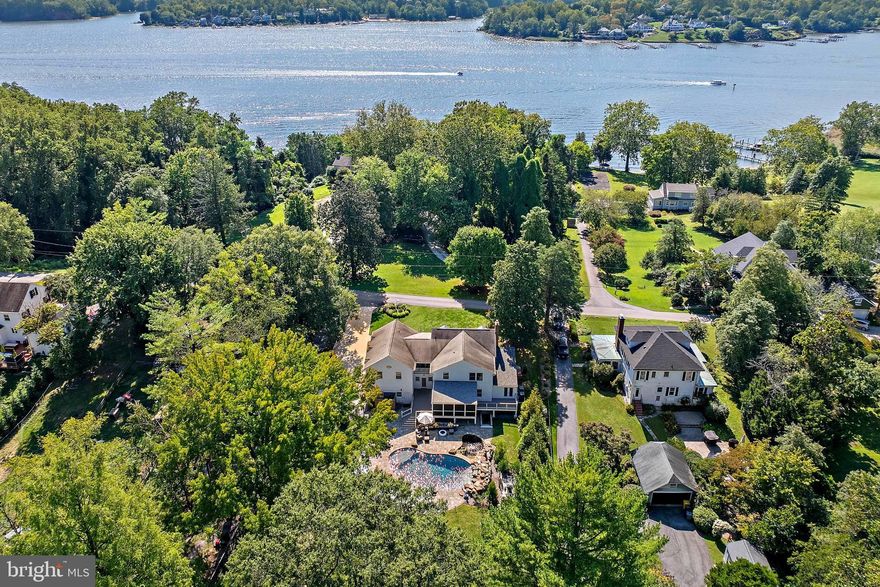 Welcome to this timeless four-bedroom residence, tucked away on one of the most beautiful waterfront lanes in Anne Arundel County. Set on 2.3 acres framed by mature trees, this property offers privacy, serenity, and an unmatched sense of place. 
The backyard is a true oasis featuring a sparkling saltwater pool, outdoor shower, koi pond and expansive entertaining areas—perfect for summer gatherings or quiet evenings at home. Across the street, an additional deeded 0.06-acre lot provides 15 feet of waterfront on The Severn River with a pier storage unit and seating area, offering a front-row seat to the Chesapeake lifestyle.
Classic in design and surrounded by top-rated schools, this home blends charm, comfort, and outdoor living in one of the county’s most sought-after locations.  Severna Park Schools, A true Chesapeake retreat!