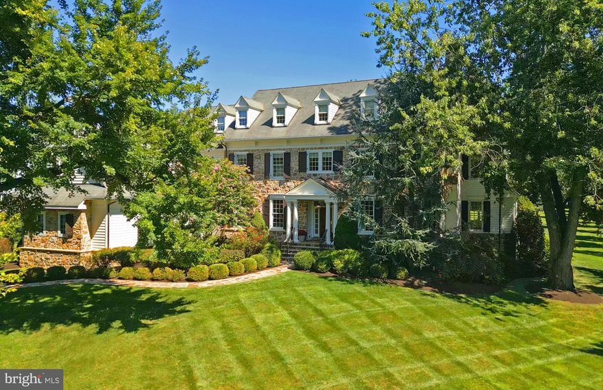 Introducing an extraordinary Main Line estate nestled on a tranquil 1.5-acre oasis within the heart of Radnor Township. This remarkable 6 bedroom residence boasts 4 full and 2 half baths set on a private, flat lot with mature trees and landscaping. Its harmonious blend of a contemporary, practical layout is ideally suited for today's discerning buyers. Upon entering the grand center hall, you'll be immediately captivated by the timeless traditional accents gracing every corner – from exquisite crown molding and transom windows to elegant wainscoting and pocket doors. To your left, an inviting formal dining room bathed in natural light awaits, adorned with transom windows and wainscoting, seamlessly connecting to the expansive, open kitchen and living space. To your right, a sun-drenched formal living room, featuring a gas fireplace and a stunning coffered ceiling, leads gracefully to a private study with glass pocket doors at the rear. French doors unveil the charming rear slate patio, complete with a built-in BBQ and a cozy firepit, perfect for al fresco gatherings. The gourmet kitchen stands as a culinary haven, boasting a sizable island with seating, bespoke cabinetry, custom tiled backsplash, Sub-Zero refrigerator, and a GE Thermador 6-burner stove, along with an additional bar area with glass cabinets. Bathed in light, the adjacent breakfast room and family room reveal vaulted ceilings and floor-to-ceiling windows overlooking the lush backyard. Custom built-ins and cabinetry frame the gas fireplace, with stone surround in the family room. The first floor is rounded out by a convenient second rear staircase, a functional mudroom complete with cubbies, pantry, garage access, a powder room, and an exit to the side yard. Ascending to the upper level, the primary suite occupies its own private wing. A generously sized sitting room with a fireplace and built-ins opens onto the spacious bedroom featuring double crown molding, a walk-in closet, and a spa-like bath, replete with double vanities, a soaking tub, and a walk-in shower. Two hall bedrooms (one currently serving as a walk-in closet) share a Jack and Jill bathroom, while an additional two bedrooms, a hall bath, and a laundry room complete the second floor. The third floor unveils an expansive bonus area that can be transformed into an entertainment room or additional living space. The sprawling lower level presents an entertainer's paradise with a wet bar featuring custom cabinetry, wine storage, and a beverage fridge. Complemented by a game area, gym, cedar closet, living room, bedroom, a full bath and additional storage, it offers endless possibilities. Additionally, this home boasts a 4-car garage, a delightful rear slate patio with BBQ and firepit, and a flat rear yard. Set within the award-winning Radnor School District and surrounded by all the amenities of Bryn Mawr, this property represents the epitome of Main Line luxury living.