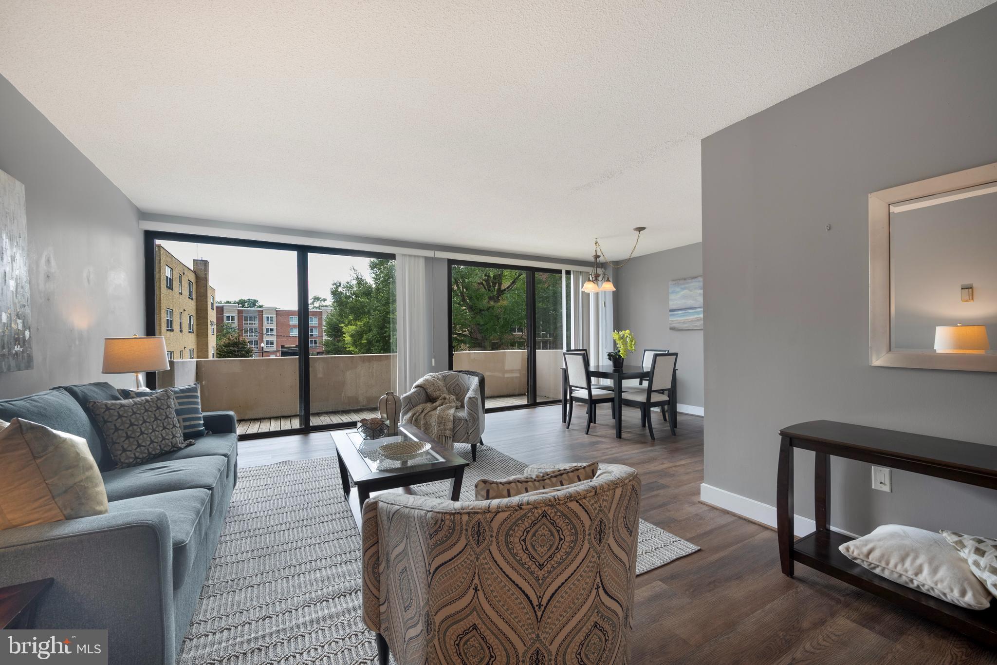 Live the Urban Lifestyle in Ballston! Welcome to this spacious and sunlit 945 sq ft one-bedroom condo in the heart of Ballston — just four blocks from the Metro and steps from Harris Teeter, Ballston Quarter, and everything this dynamic neighborhood offers. Featuring floor-to-ceiling windows and a 20-foot private balcony overlooking the pool, this home brings resort-style living to your everyday routine.
Enjoy the elegance of new hardwood floors (installed October 2024), an open and flexible layout, and generous storage including a walk-in closet, coat closet, and linen closet. The condo fee includes all utilities, so you can enjoy hassle-free living in a professionally managed building. Hyde Park offers unmatched amenities: a community pool & wading pool, beautifully landscaped grounds, a night-time security guard, and more. With a prime location surrounded by restaurants, shopping, green spaces, and commuter options — this is perfect for young professionals seeking convenience, comfort, and style in the heart of Arlington.