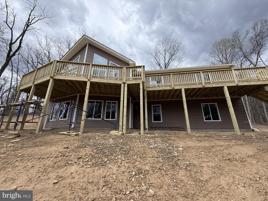 New Construction Ready End of April 2025! 1620 Above Grade Finished Sq. St., 3 Bedrooms, 2 Full Baths.  All The Upgrades, Bells & Whistles! Vaulted Ceilings, Vinyl Plank Flooring Throughout, Open Floor Plan With Great Room Opening To The Kitchen, Great For Entertaining. 36 Inch Wood Burning Fireplace With Mantel, Granite Counter Tops, Upgraded Stainless Steel Appliances. Main Level Laundry For Added Convenience.  Master Suite, Upgraded Tiled Luxury Shower With Walk In Closet. Full Basement With Lots of Natural Light with 2 Car Garage. Enjoy Full Length Front Porch & Rear Deck. Enjoy Large 5 Acre Wooded Lot No Mountain Roads To Travel. Easy Access to I-66.