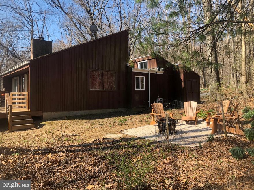 Looking to own your own vacation rental, full time residence, or private weekend retreat- This cabin offers the luxury of any of these options. This property is a contemporary 3 bedroom, 2 bath cabin located in the iconic Coolfont Mountainside Community and a successful vacation rental. Property features are endless with an open concept living space with bamboo flooring, spacious kitchen with upgrades, a large living room with a fireplace and new sliding doors, tiled entry way, and some furnishings are included. The master bedroom has a private full bathroom and a sitting room  for additional space.  Outdoors you'll find a large back deck over looking the WV mountains. Community features hiking trails, tennis and basketball courts, a tot-lot, and rec field. Memorial Day-Labor Day the community in ground heated pool and hot tub are offered as well.