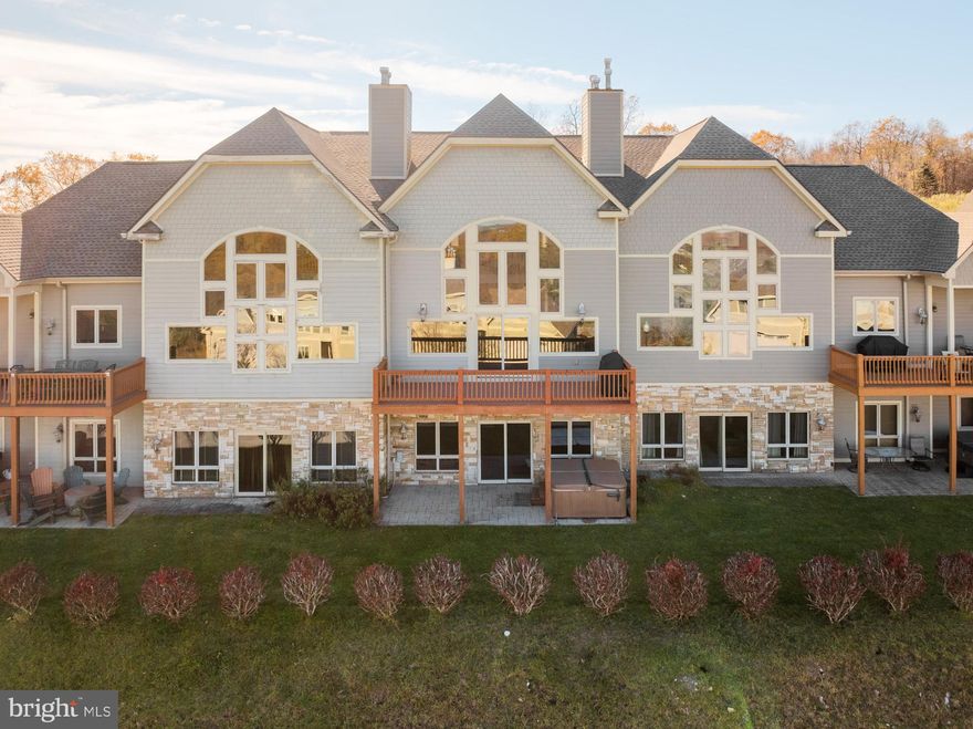 Nestled at the peak of Wisp Mountain in the Overlook Villas community, you will find this spacious townhome overlooking the beauty of Deep Creek Lake. This exceptional property blends alpine charm with modern luxury, offering a lifestyle as spectacular as the scenery. With three levels of living space, an open floorplan, hardwood flooring, cathedral ceilings, three en-suites, a large loft, and two-family rooms, you and your guests will have ample space to spread out. The abundance of windows brings the outdoors in during any season, while also offering stunning mountain and lake views.  The community amenities are abundant and include: the use of an outdoor pool, club house, tennis courts, playground, walking paths, and a lake access area. Call today to preview!