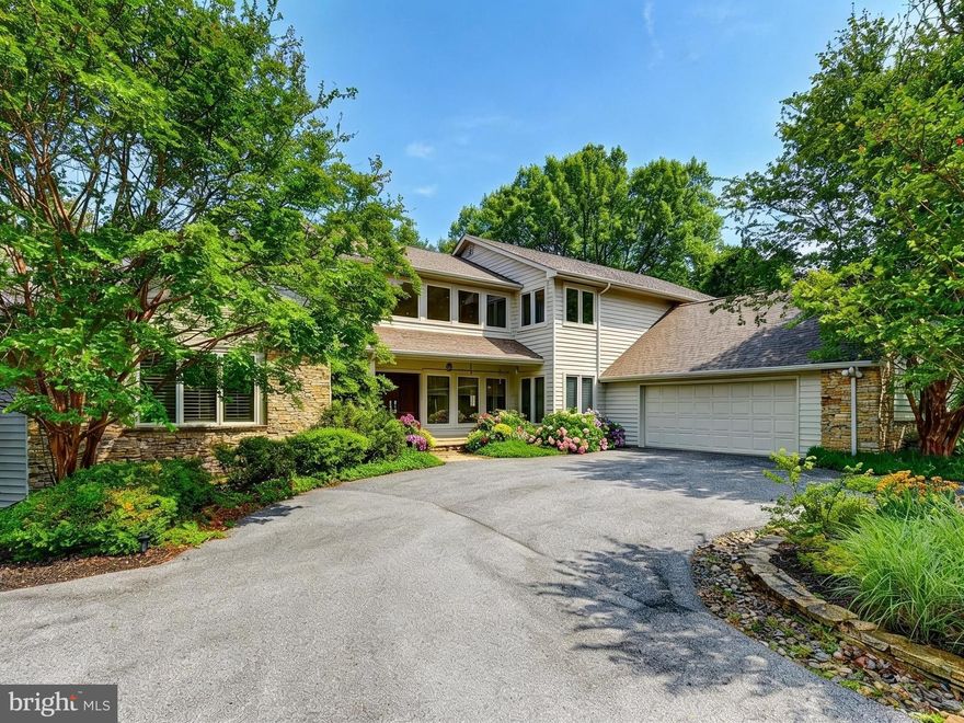 Wow! Bright & Spacious custom contemporary with 1st floor Primary Suite, 2-story and cathedral ceilings, gleaming hardwood floors & tons of glass on this 1.5-acre lot set back on cul de sac with circular drive!  The granite & stainless Chef's Kitchen with island and breakfast area opens to a dynamic Family Room with cathedral ceiling, stone fireplace and multiple doors to wrap around deck!  The 2-story Foyer opens to the Living Room with high cathedral ceiling, Dining Room, Den now used as an office and Guest Powder Room. The Primary Bedroom suite with updated Primary Bath and plantation shutters is fabulous!  And the 2nd Powder Room and the Mud Room complete the main level.  The Upper Level includes an ensuite bedroom and bath and 2 additional bedrooms with a jack & jill bath.  The walkout Lower-Level Rec Room is perfect for entertaining and 5th bedroom & bath provides perfect guest quarters!  This special home has gorgeous hardwood floors on the main and upper levels, is all neutral & has so may updates and upgrades throughout including marble counters in updated baths, 3 zones HVAC & more! Don't miss seeing this spectacular home today!