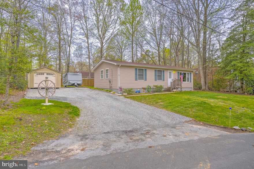 Discover this water-oriented gem at 765 Crazy Horse Trl in Lusby!
This charming and energy-efficient 3-bedroom, 1-bath home offers vaulted ceilings, tons of natural light, and both front and back yards—ideal for relaxing or entertaining. Enjoy the spacious flat lot, mature trees providing natural privacy, and a massive 14x24 ft detached garage/workshop with plenty of parking. The 8x12 ft shed, picnic table, washer/dryer, and fridge all convey—and the swing set can stay, too! Conveniently located near local parks, schools, and just minutes from the beach and bay, this Southern Maryland retreat blends comfort, space, and practicality.