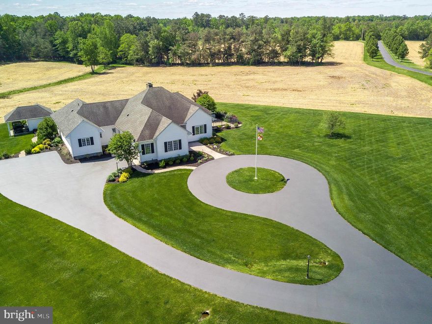 Welcome to Loyal Companion Farm!! This 107-acre working vegetation farm has so much to offer.  The tree lined 1/4-mile paved driveway welcomes you to the most tranquil setting.  The turn-key ranch home with nearly 3200 sq ft of space all on one level is perfectly finished.  As if nine-foot ceilings were not enough, some rooms showcase back-lit tray ceilings for bonus character.  Eight-foot double front doors open to an elegant Brazilian Cherry hardwood foyer and formal living with a built-in one-of-a-kind custom bar including stainless steel mini-fridge and wine fridge.  This living area opens another set of double doors to the pool area veranda.  The kitchen is central to the home and features Douglas Fir period style Maine custom cabinetry, upgraded stainless steel appliances, 6 burner commercial dual-fuel range, a walk-in pantry and a large island.  Kitchen seating also showcases an oversized custom fireplace and a pellet stove for toasty evenings throughout the winter.  The family room adjoins the kitchen and has matching Douglas Fir coffee wet bar with mini fridge.  This family room includes yet another custom built-in entertainment center with theater surround sound.  The home includes a whole home audio system exhibiting iPad, SiriusXM, FM sources and an 11-zone speaker system.  It also has a 13-zone in-ground sprinkler system and an underground dog invisible fence that allows acres of safe roaming.   This home perfectly divides the primary en-suite with the other two bedrooms.  Private primary en-suite features an extra-large bath including custom tile walk-in shower, spa-sized tub, double vanity, and see-through propane fireplace.  It also includes a walk-thru closet for two and an adjoining laundry facility with plenty of storage cabinetry.  The secondary en-suite features a walk-in closet and a custom tile bathroom.  The third bedroom makes for an oversized office as well with a deep closet to hide file cabinets.     From the primary en-suite, kitchen, living room, and office/3rd bedroom, you step out back to the covered patio leading to a 28000-gallon midnight blue PebbleTec surface saltwater pool surrounded by pavered hardscape, plant covered softscape, and a soothing waterfall. Pool area is fenced and has private pool house with the third en-suite.    The west side fenced dog-area was created with a walk-in shower to serve as a dog wash station before entering the home.   The detached 1800 sq ft garage has three bays showcasing manicured epoxy floors, another pellet stove, industrial cabinetry and a man-cave serving as the fourth en-suite with a huge walk-in closet.  This facility has 900 sq ft rear overhang for extra covered parking.  On the second level, there is a 1200 sq ft apartment with amazing farm views, large living area, large kitchen, stacked laundry, 2 bedroom, and 1 bath.  This entire building is conditioned space.   Metal Barn building has 40x60 conditioned bay for boat and RV storage, 40x60 unconditioned space for storing farm equipment and toys, and a 20x40 conditioned workshop.  But wait there's more... a private solar field that produces enough power to run the entire farm plus provides SREC income, 25 acres of farm fields, 2-3 miles of walking/ATV trails, and extensive landscaping.  This one truly has it all!!  Please respect owners privacy and do not enter property or drive without first making an appointment.