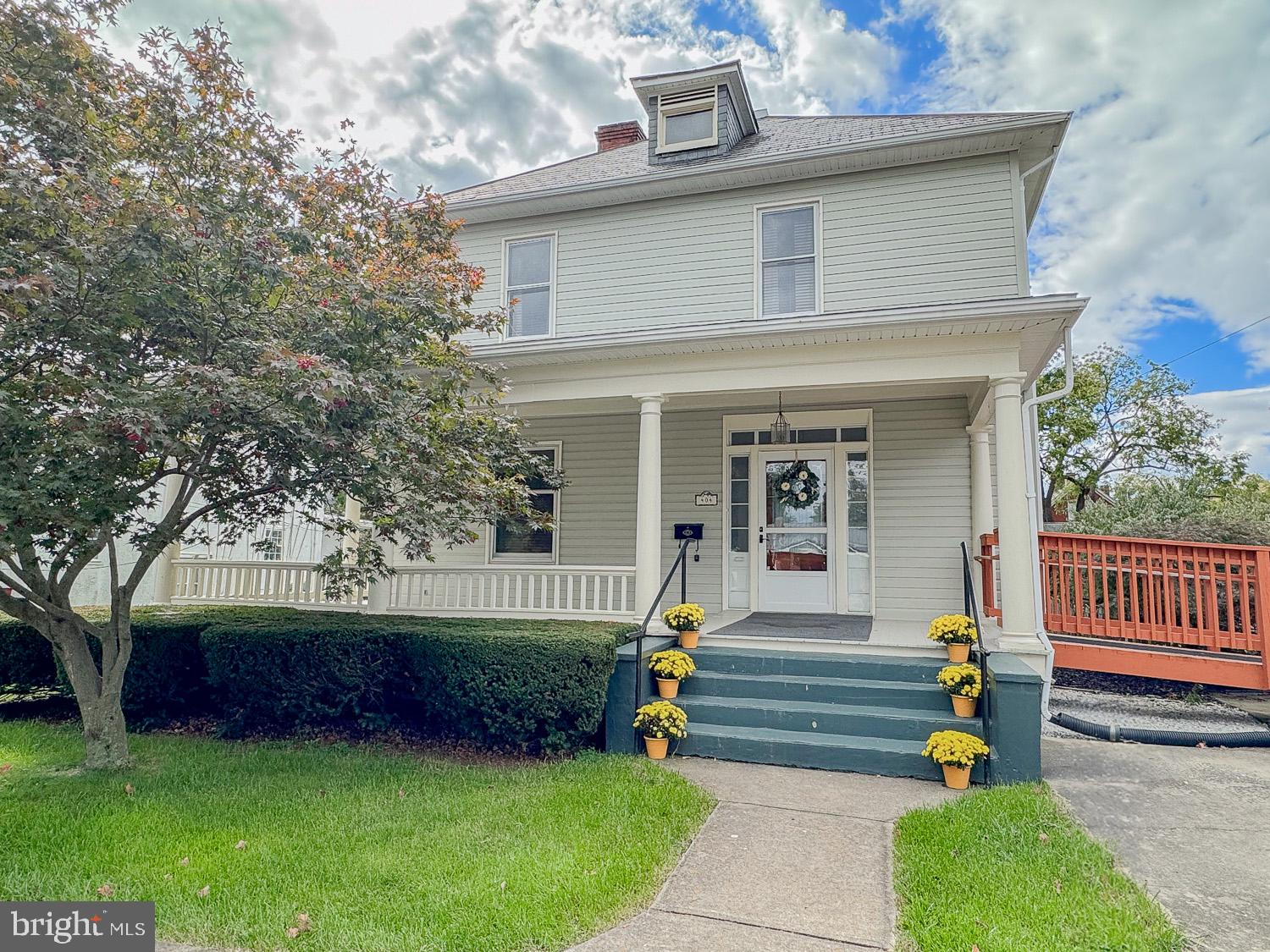 Welcome to yesteryear when homes were built sturdy and have unique qualities. Handmade spindles going up the staircase, crown molding and hardwood throughout, 9 foot ceilings and pocket doors. Great craftmanship with this beautiful Colonial with a wrap around porch within walking distance to the park and downtown. This home has 3 bedrooms, 1.5 baths. Living room with hardwood floors, crown molding,  9' ceilings  and a pocket door. Family room with crown molding, hardwood floors, 9' ceilings and a gas fireplace. Large country kitchen with pantry and a half bath. Laundry room has a door that leads to a large new deck and your park like setting fenced backyard with beautiful landscaping. A nice sized garage/ shed for storage. Upstairs there are 3 large bedrooms with hardwood floors and an extra room that was used as a walk-in cedar lined closet. One bedroom has access to a porch area that overlooks the backyard. There is extra storage in the floored attic (which could become additional living space) or the unfinished basement with a workshop. Enjoy life on your front porch or coffee on the deck overlooking your backyard.  A Must See!!